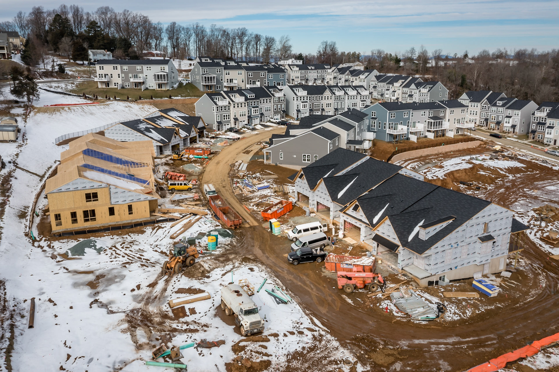 A snowy under constructure and completed view of homes in the new Spring Hill Village in Charlottesville, VA