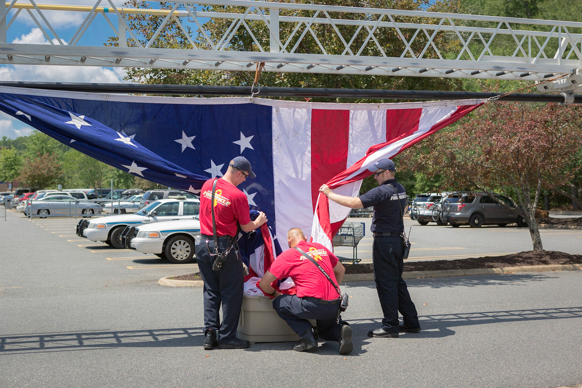 Firefighters storing the American flag