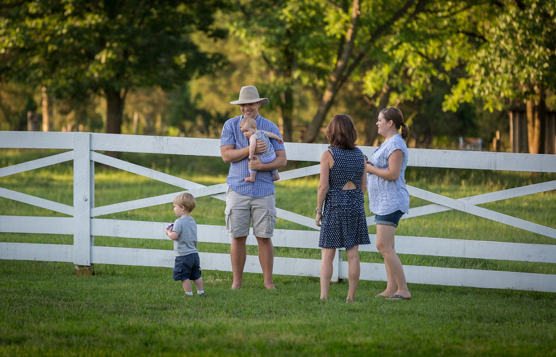 Enjoying the day by a white fence