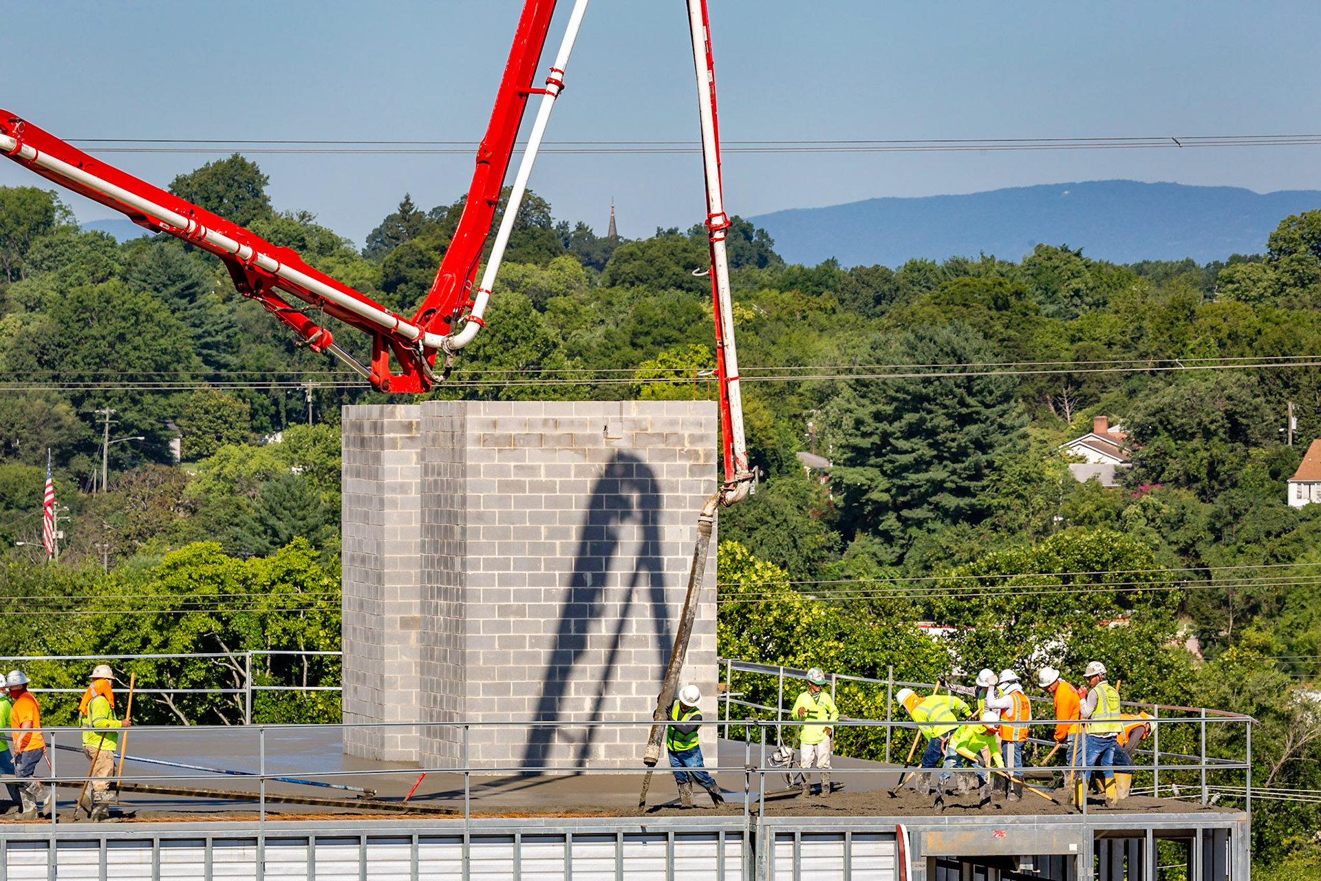 Men pouring concrete for the fourth floor of Storage Sense
