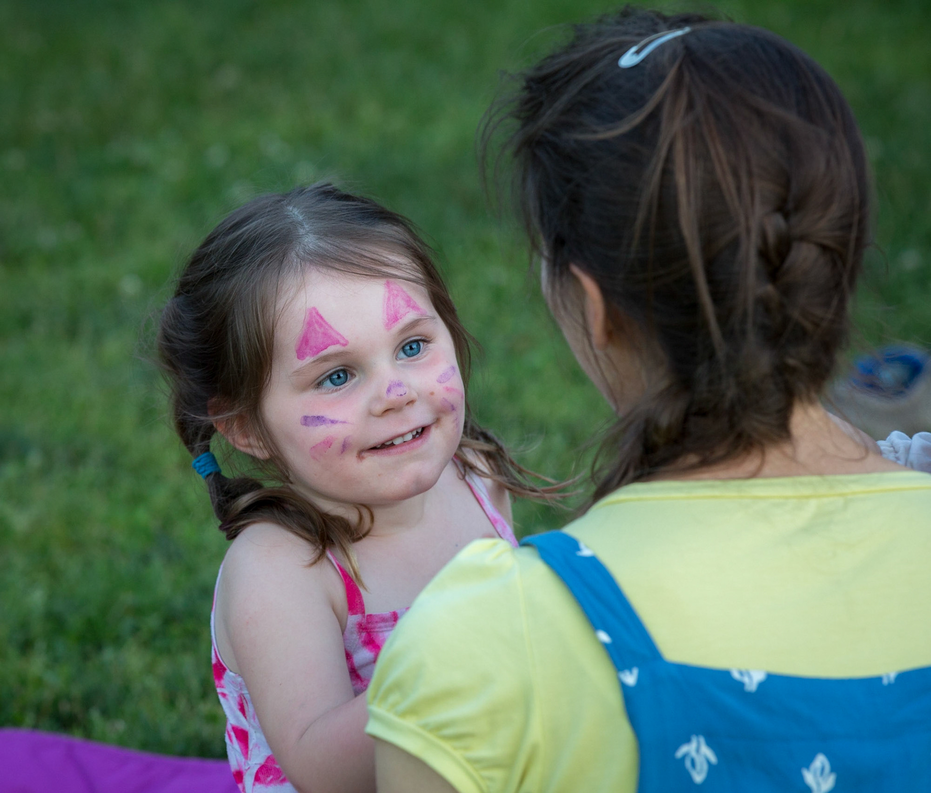 face painting, young girl looking at mother