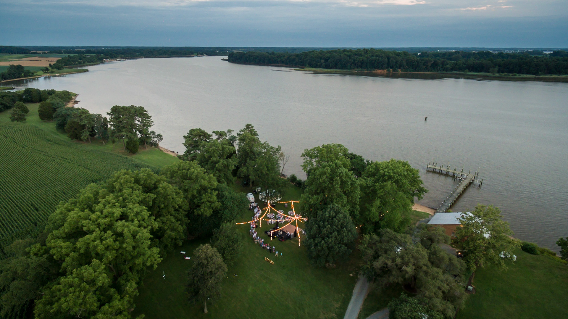 Aerial view of a wedding reception along a river