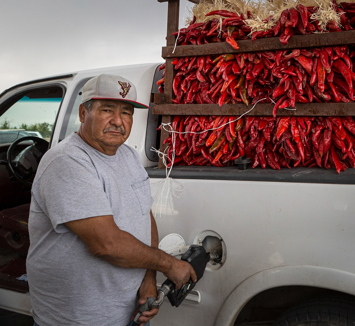 Getting the chiles to market, driver filling truck with gas