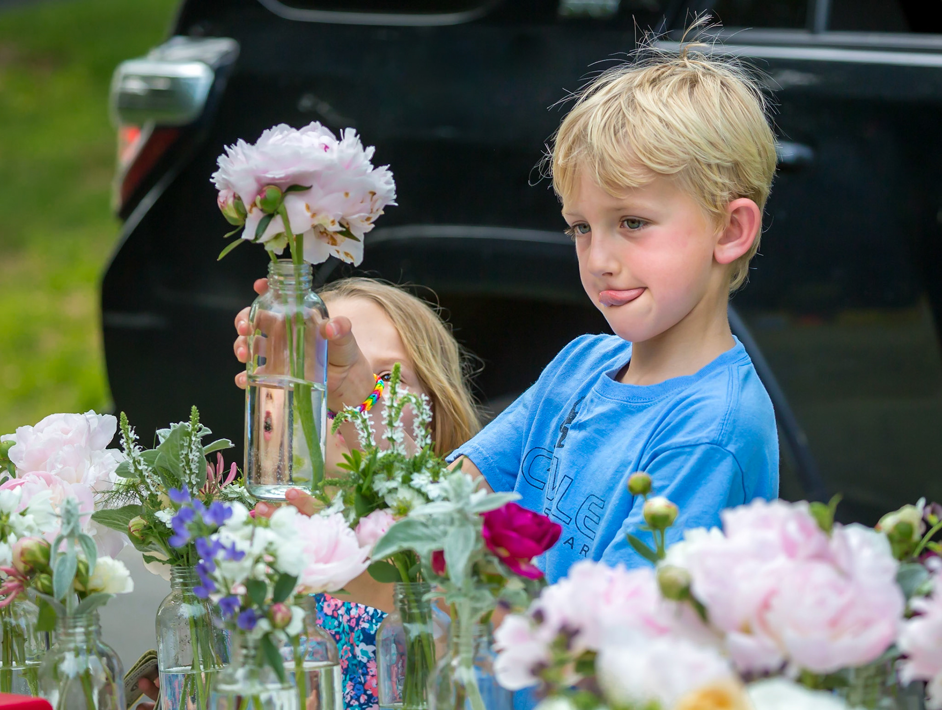 A young boy at a flower sale