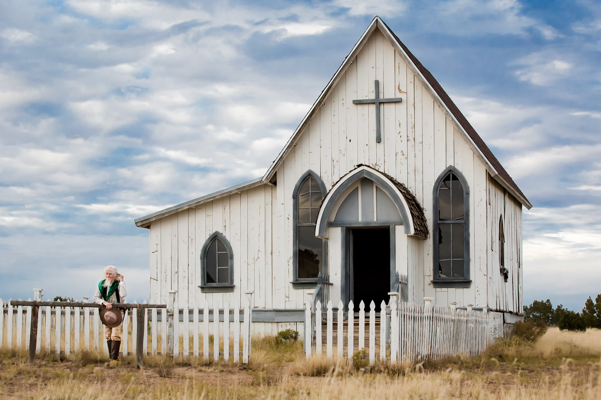 Old western church with Donald standing at the hitching post