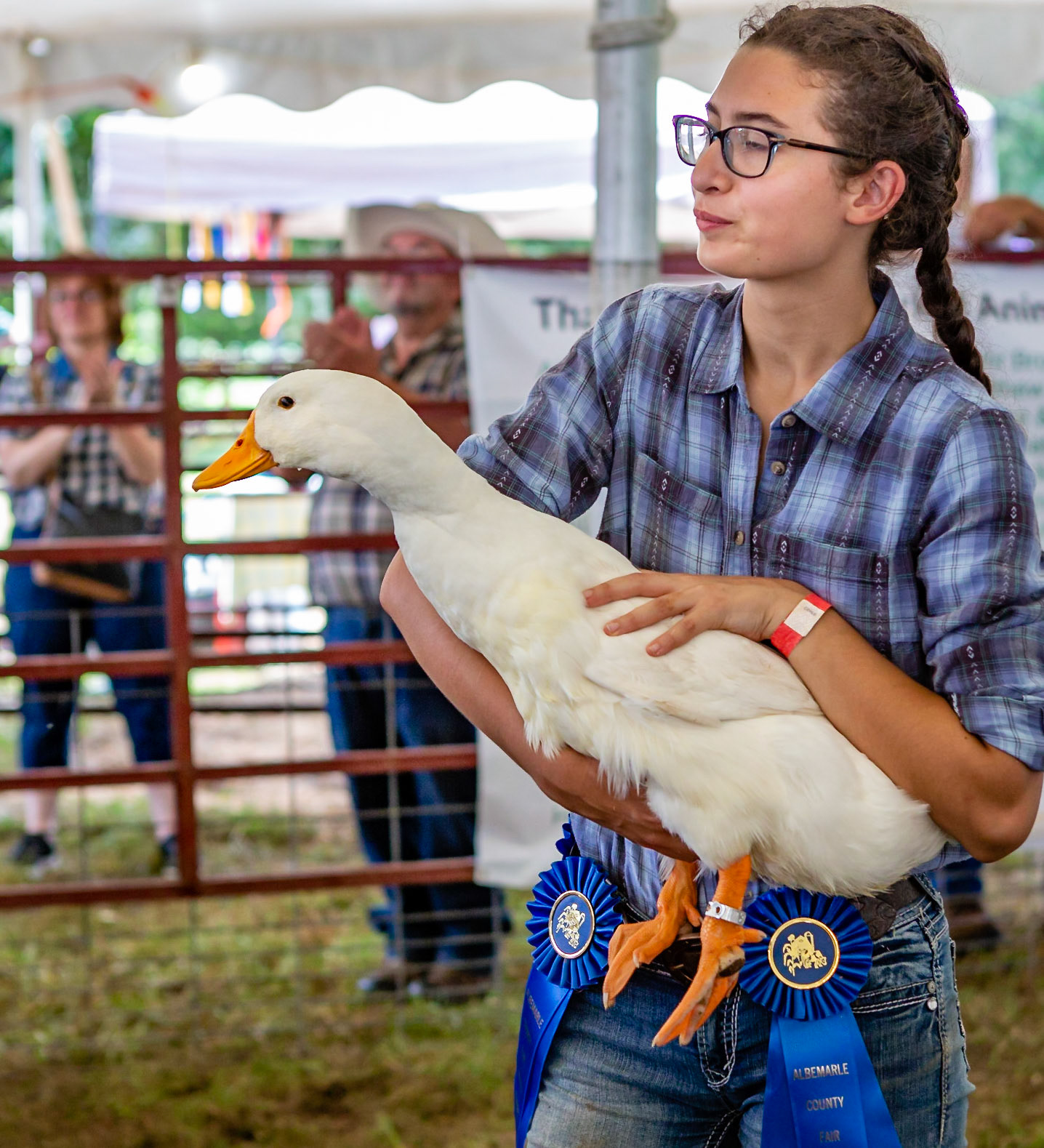 A proud young girl holding her prize winning duck