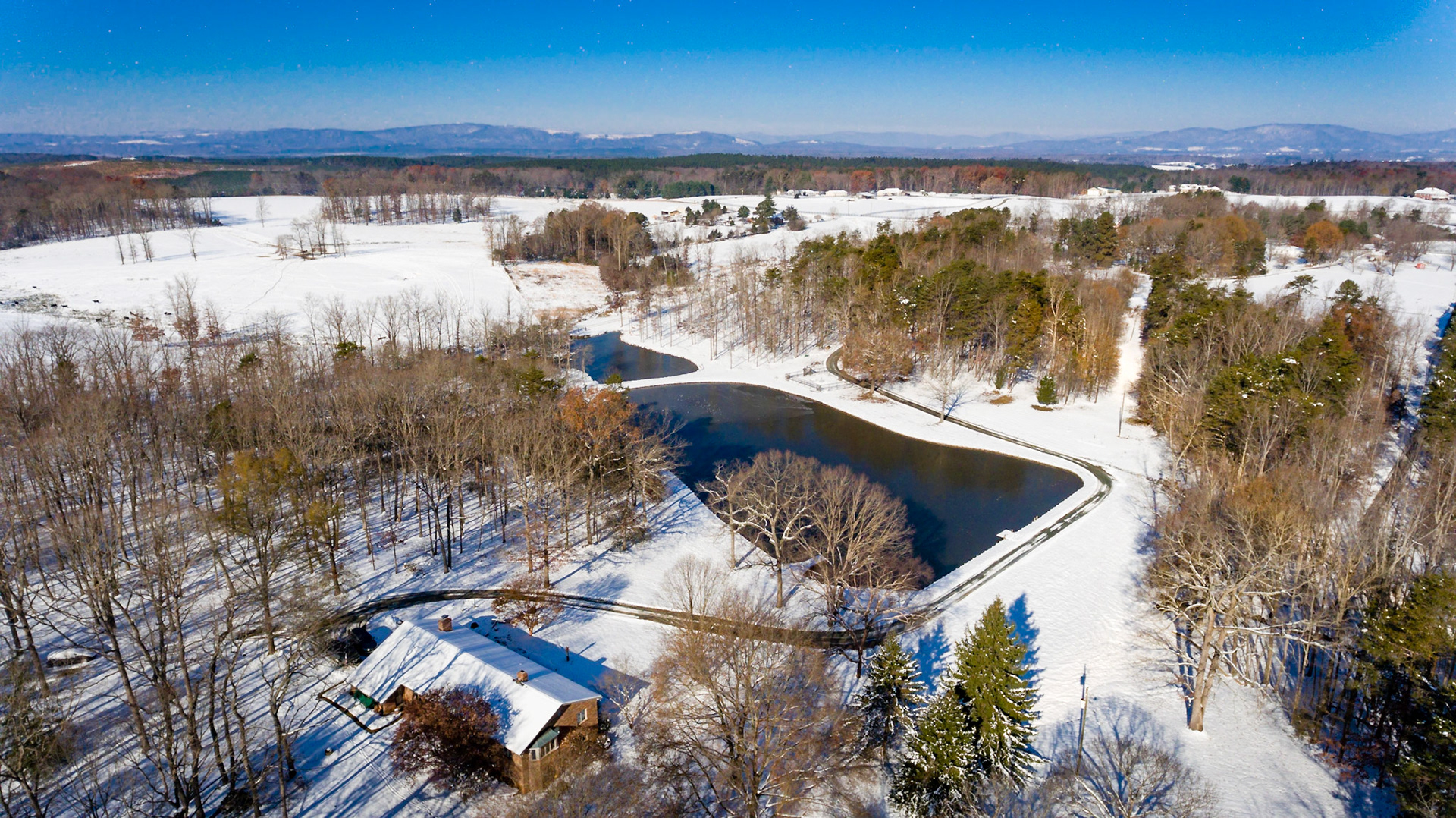 Aerial, snow, pond, mountains