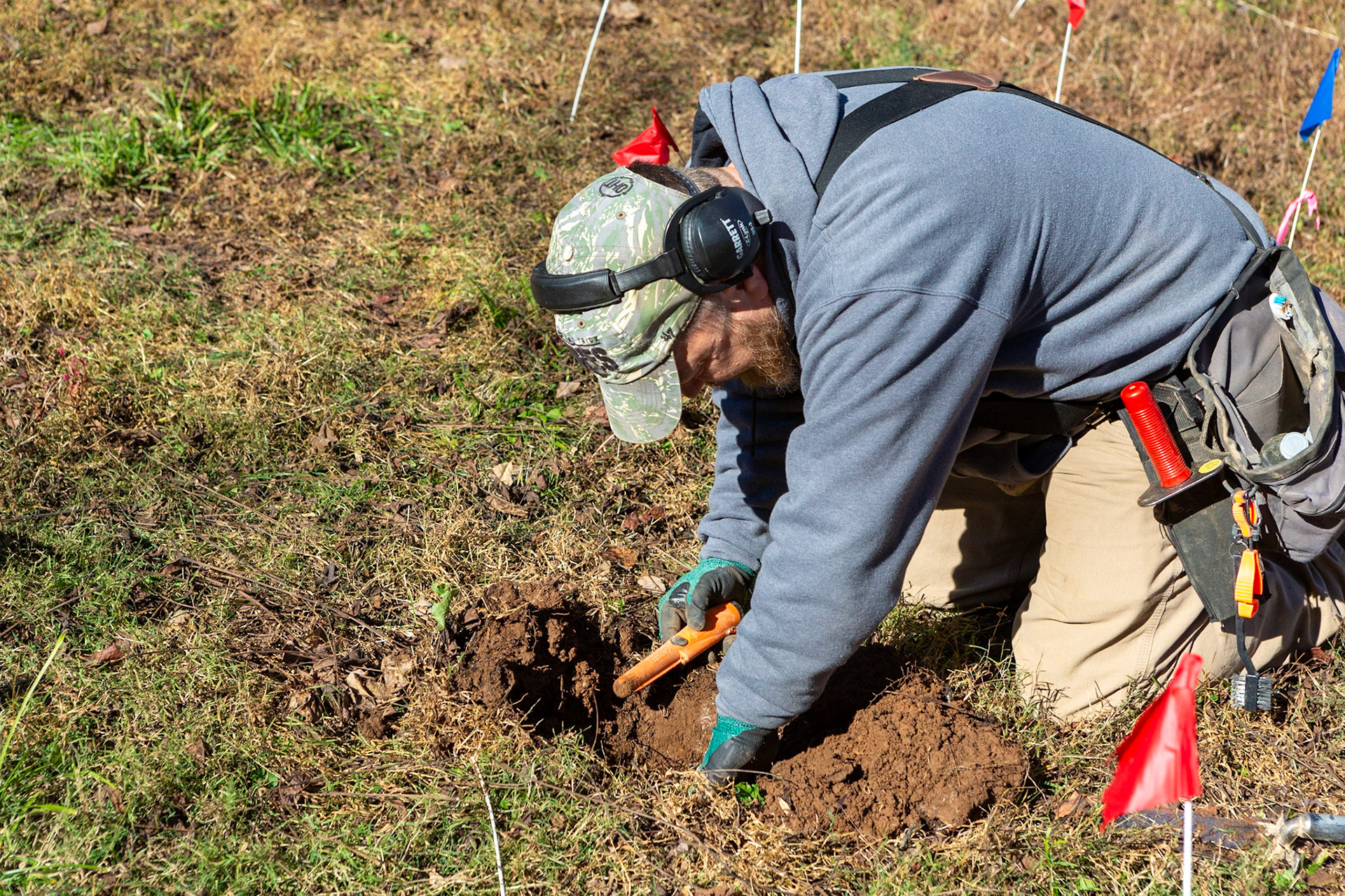 An experienced metal detector working with archaelogist at Montpelier