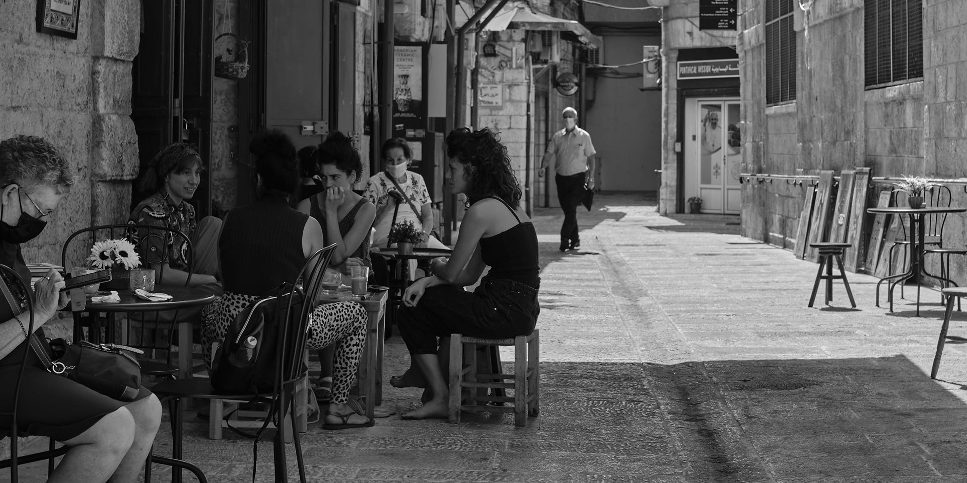 A cafe with guests in the entry street leading to New Gate in the Old City of Jerusalem.