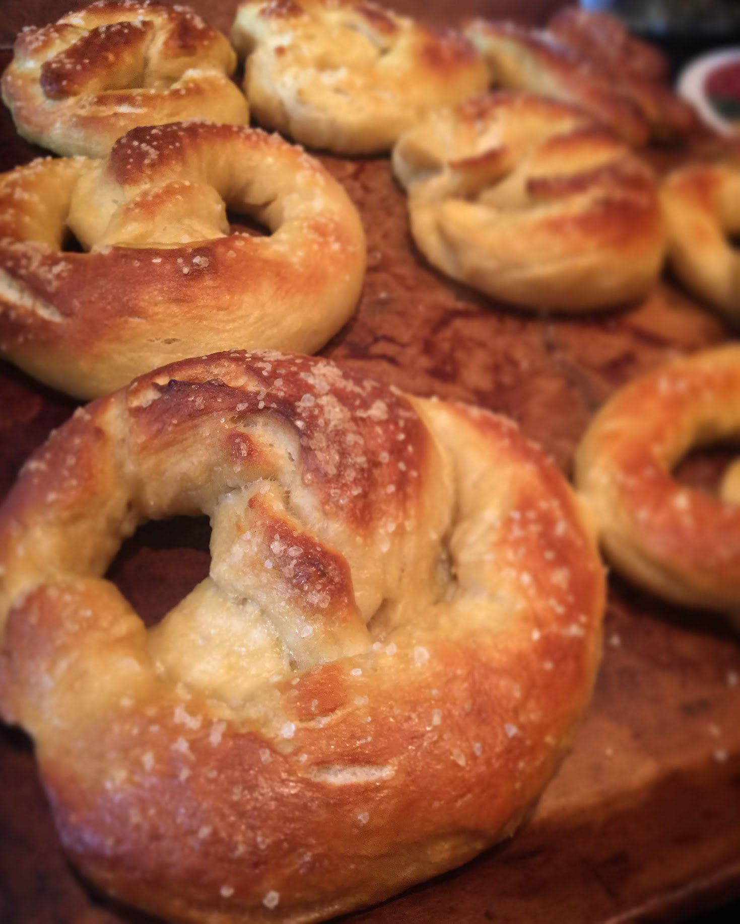 #11 German Pretzels, 2020, Photo uses depth of field and leading lines to draw the eye down the row of homemade German pretzels.