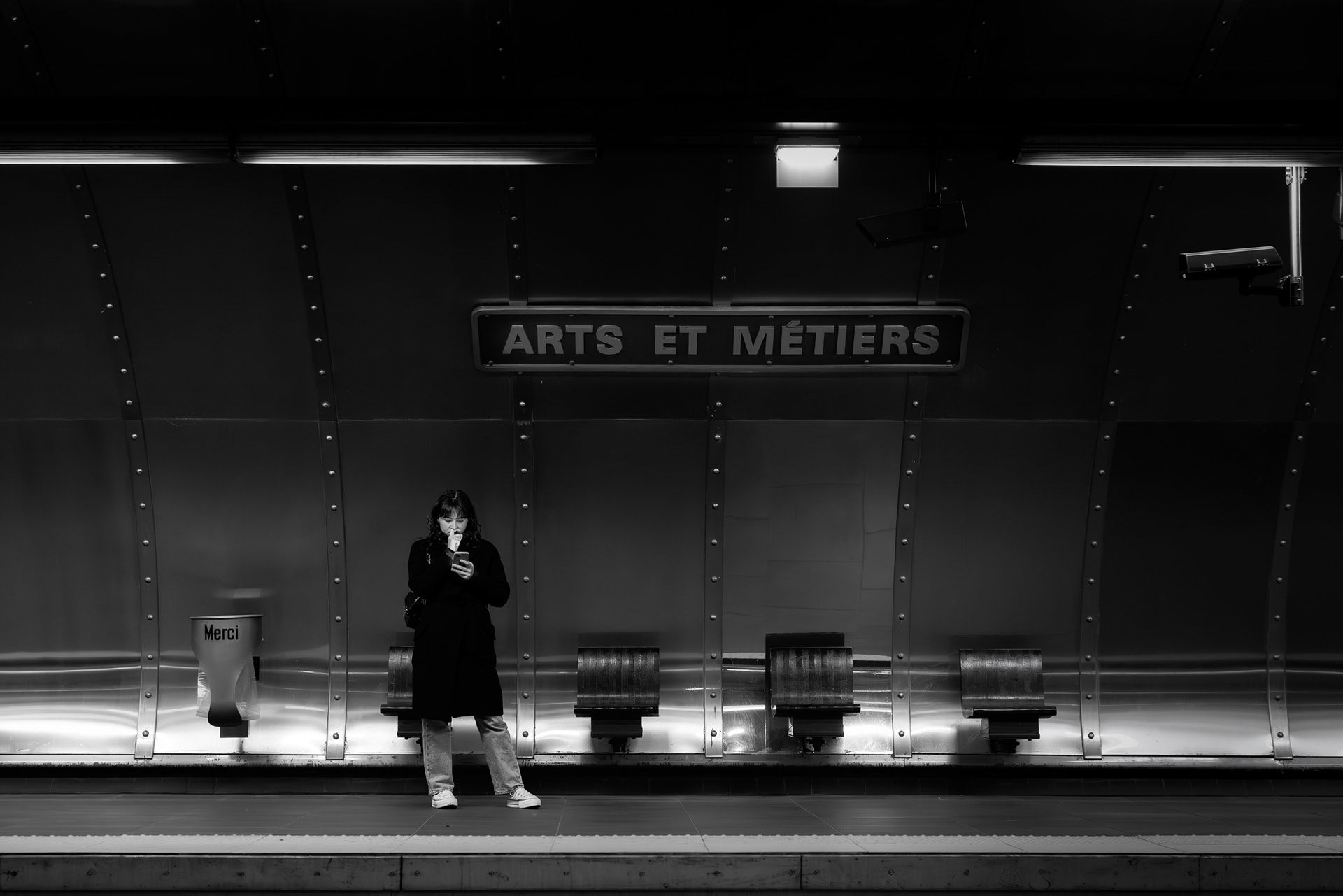 Passenger waiting on platform at Arts et Métiers station