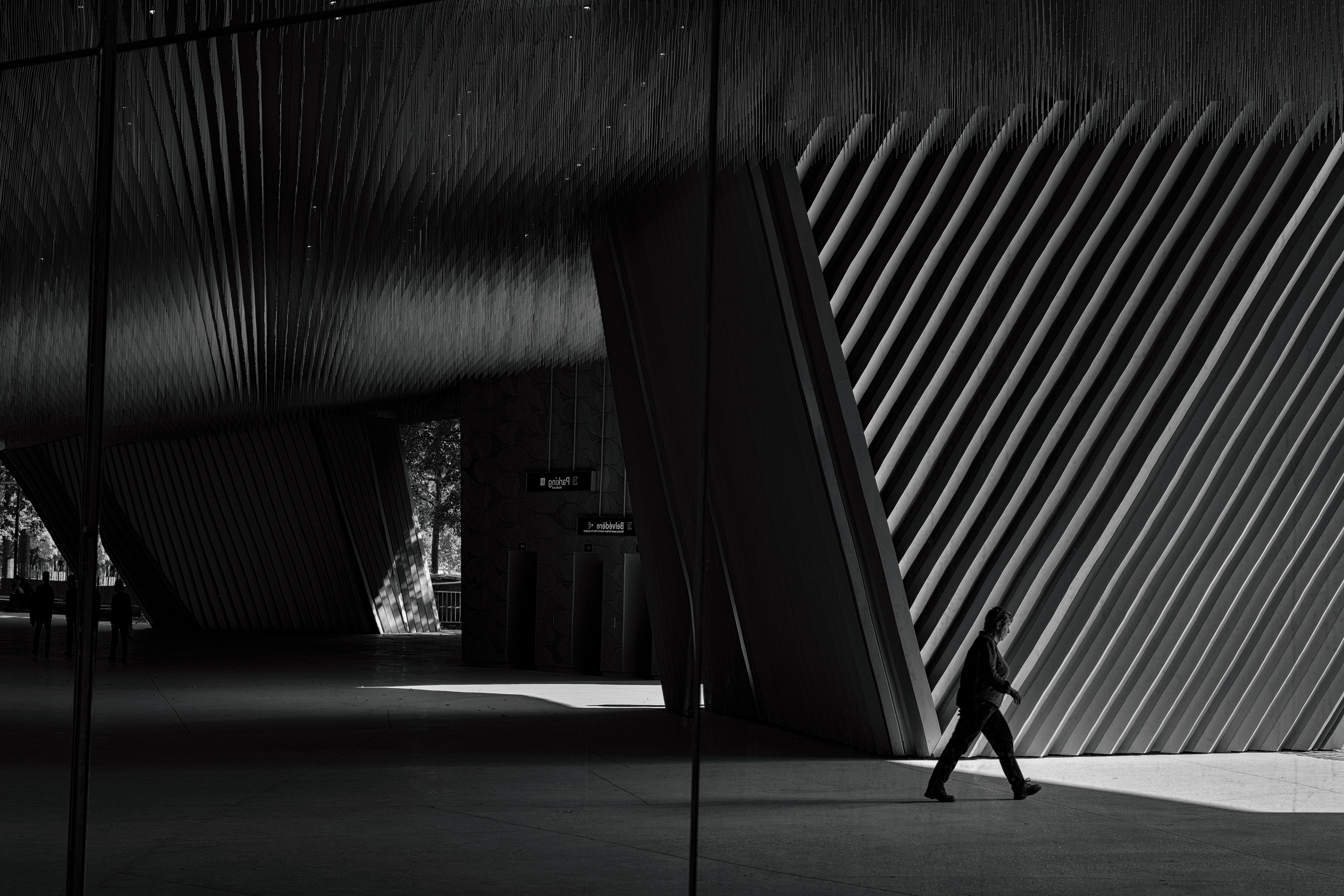 Crossing through light and shadow at the Philharmonie de Paris. Featured by Universalarthub.