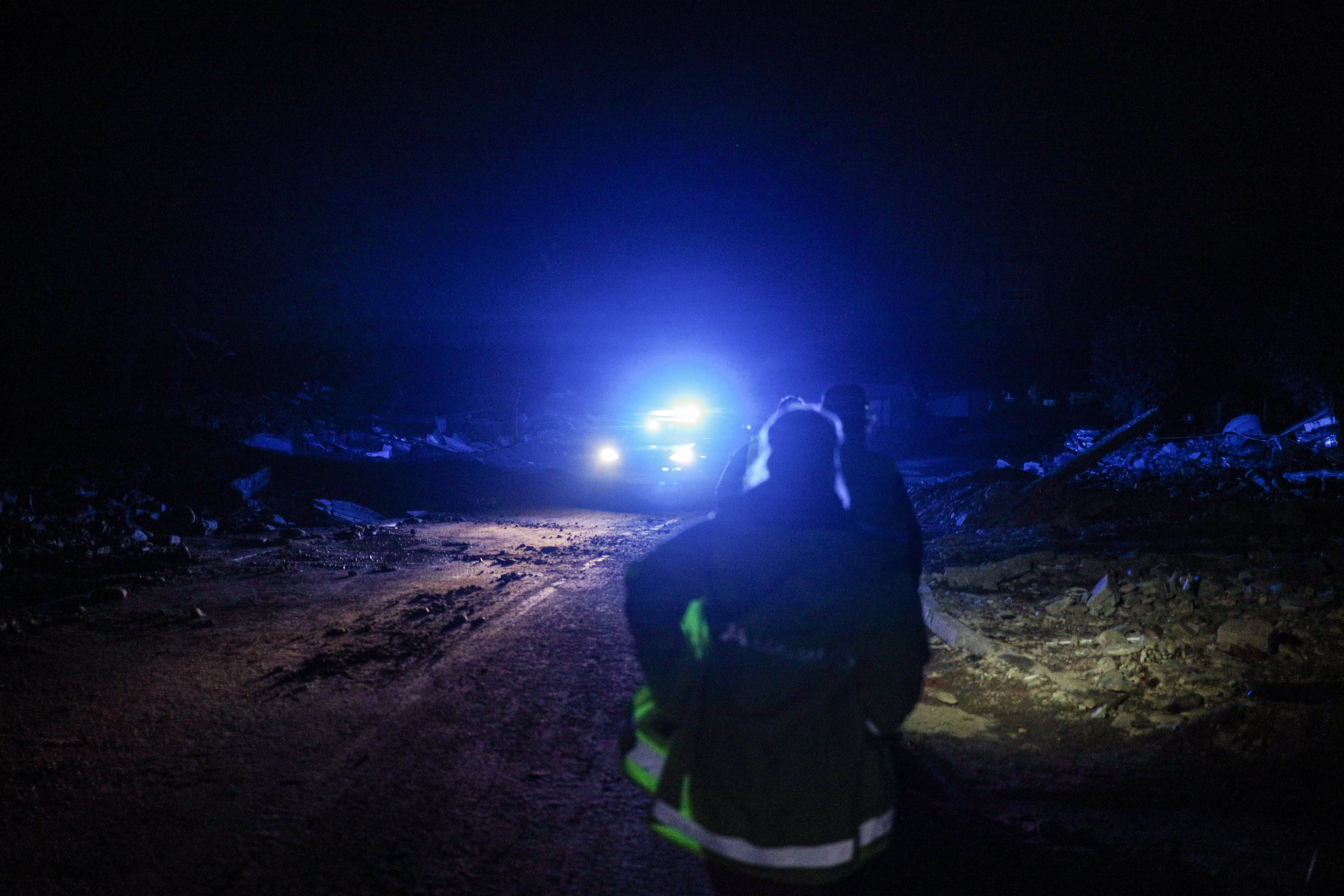 Stronie Śląskie, Poland. A resident stands on a darkened street illuminated by emergency lights, as power outages left the town without electricity after the flood.