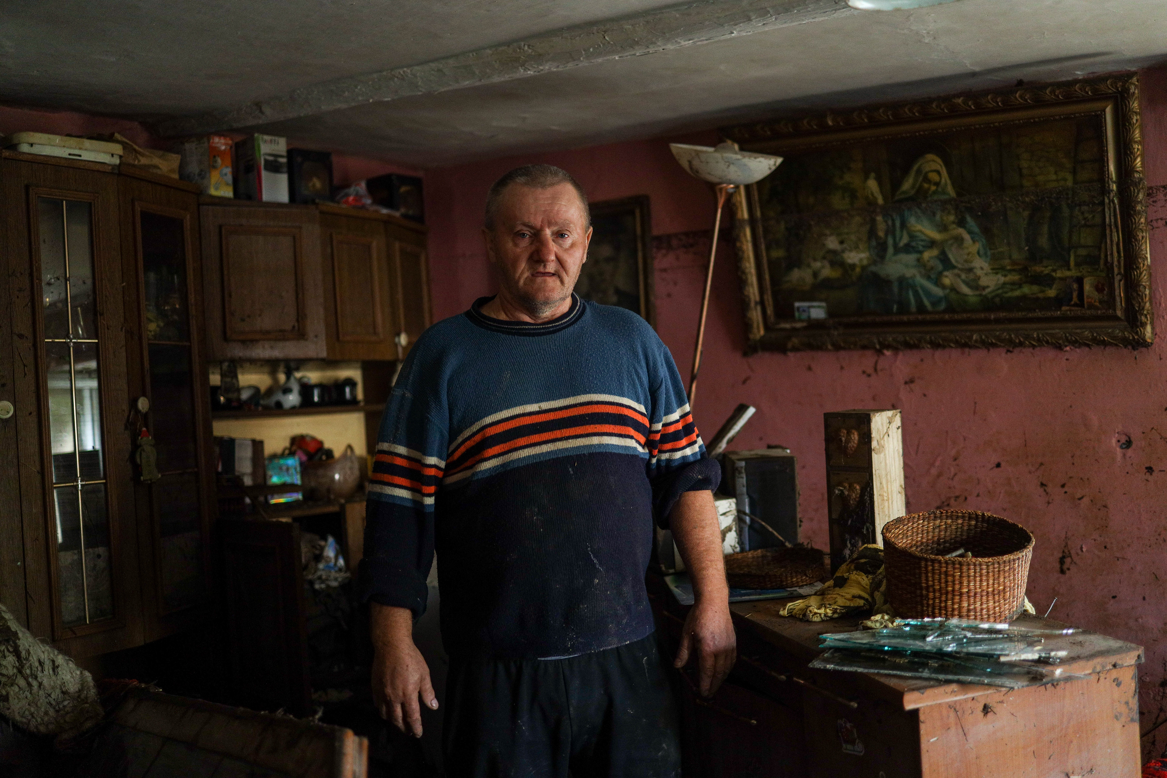 Krosnowice, Poland. Mr. Kazimierz stands in his flood-damaged apartment, where water reached nearly the ceiling. When the flood wave came, he grabbed his television and called his three cats before escaping to a neighbor living on higher ground.