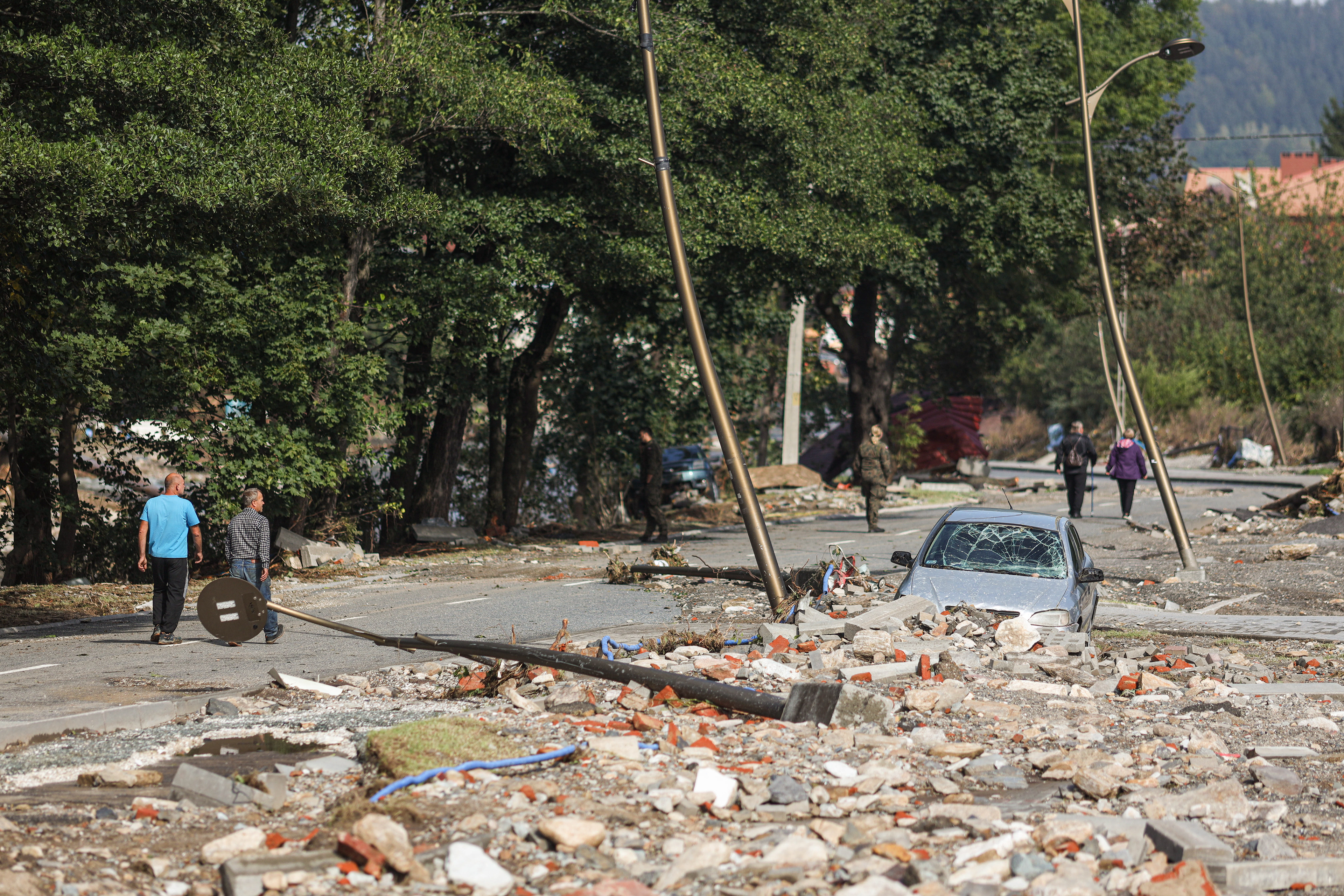 Stronie Śląskie, Poland. Residents walk through a devastated street filled with debris and destroyed infrastructure after the floodwaters swept through the town.