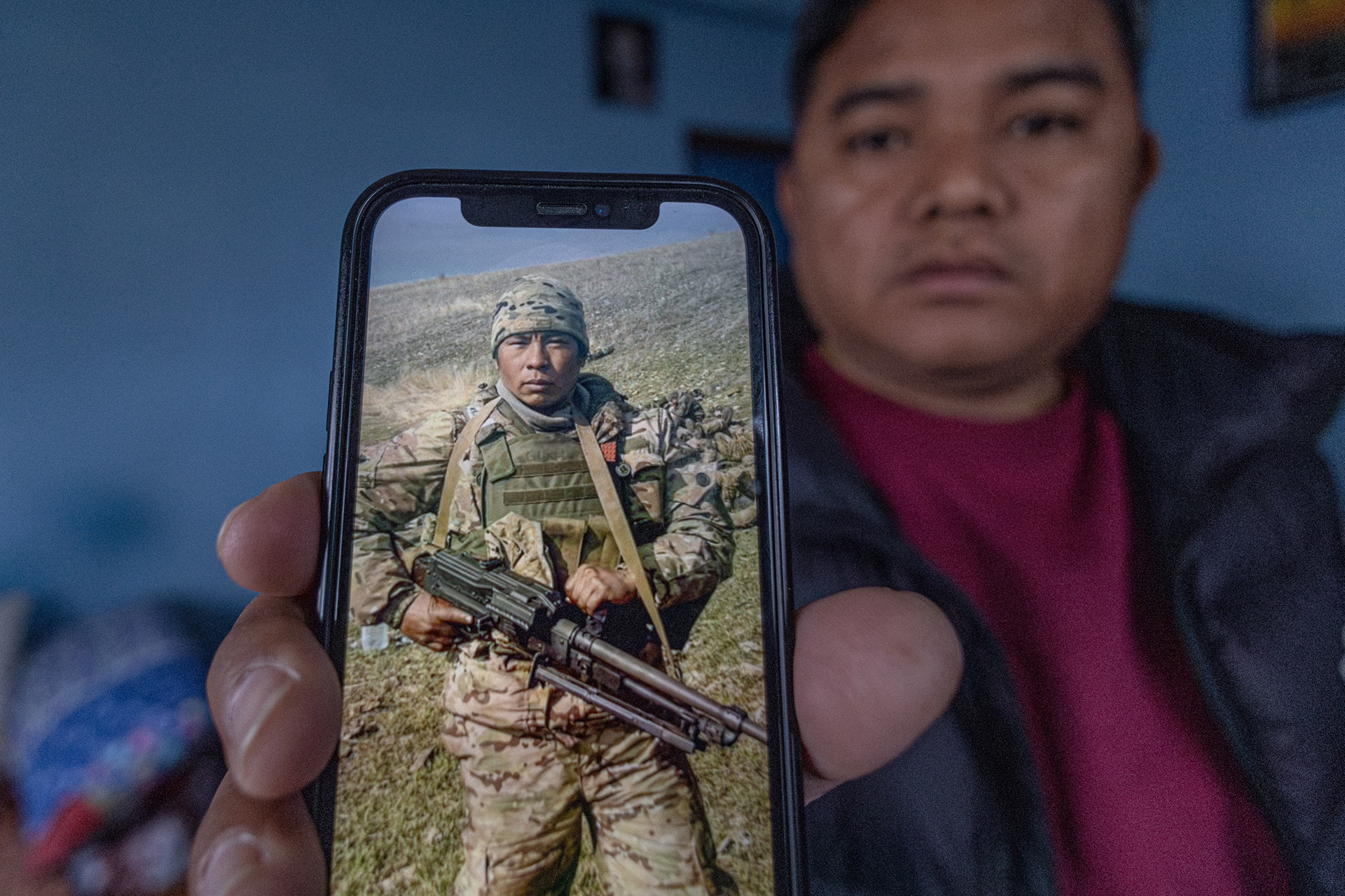 Tek Bhadur Gurung shows a photo of his brother-in-law, Minraj Gurung, who was recruited to the Russian army and sent to the war in Ukraine.