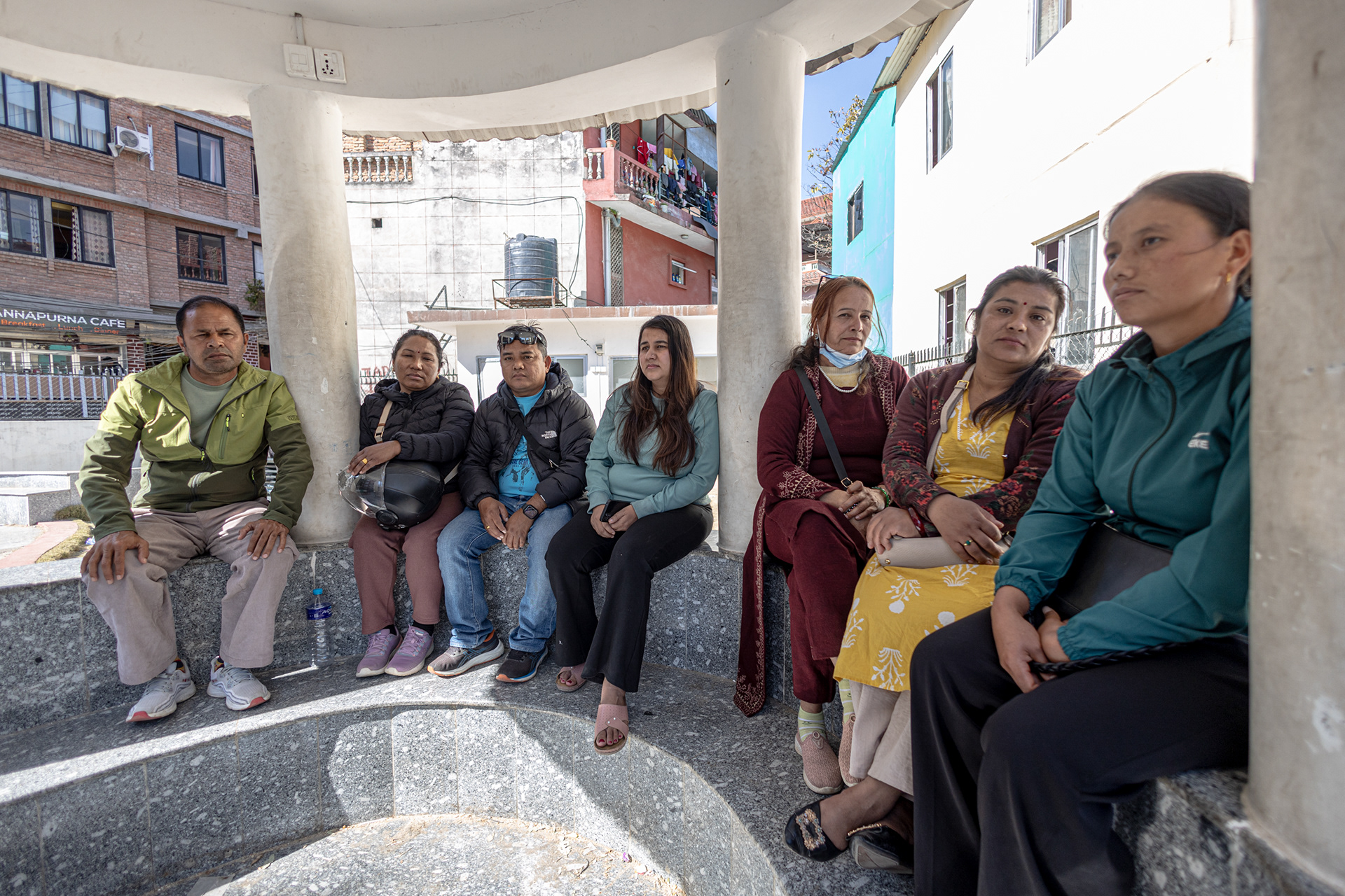 Kritu Bhandari, an activist documenting the cases of Nepali recruits, meets with families who have lost contact with relatives sent to the war in Ukraine. She is seated in the center.