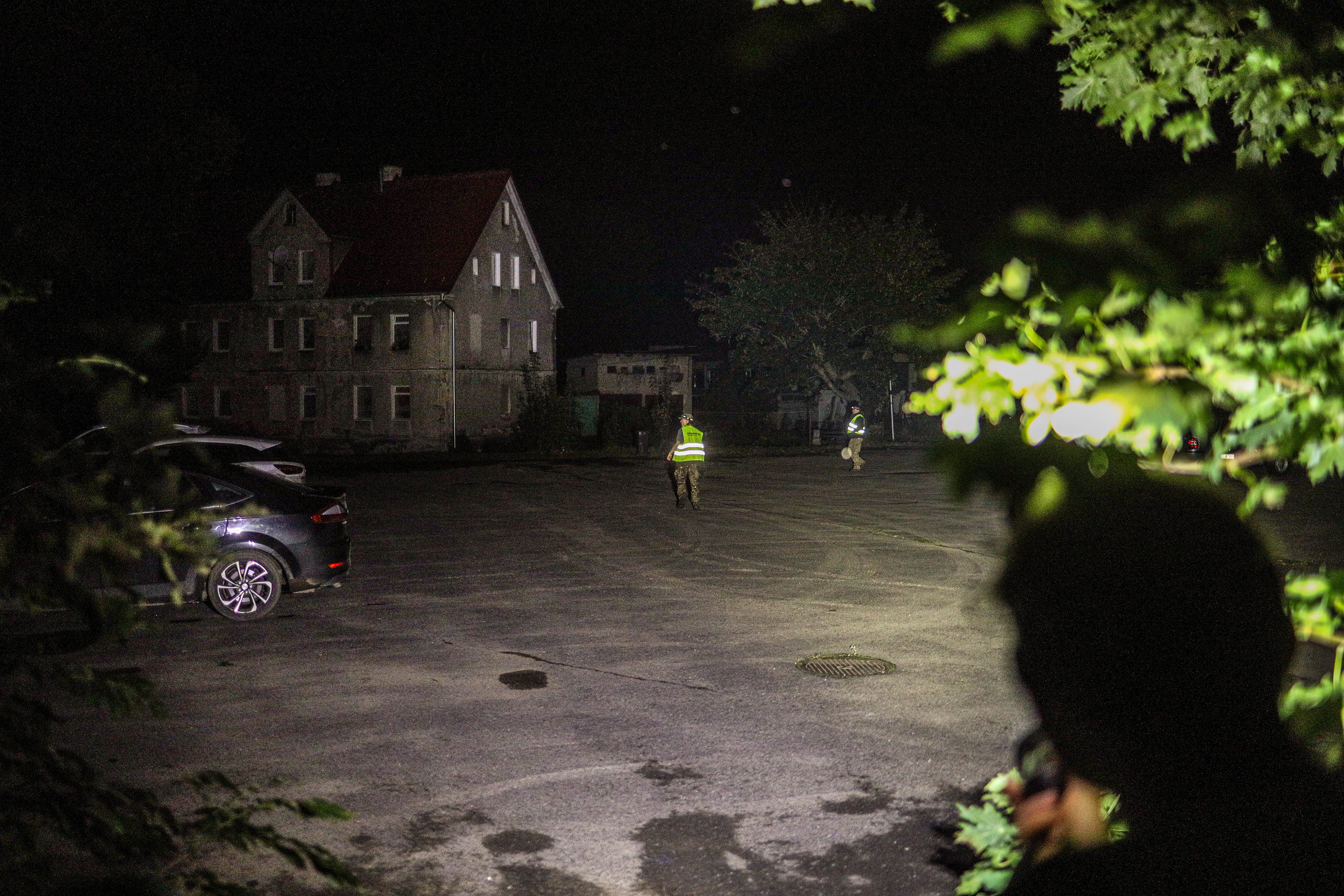Stronie Śląskie, Poland. Volunteers patrol the streets at night, using flashlights to guard abandoned homes against looting after residents were evacuated.
