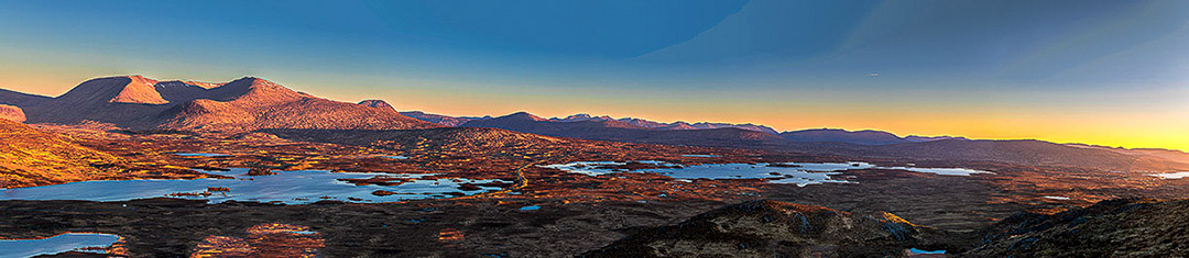 Dawn breaking over the Rannoch Moor , Scotland with the Blackmount hills of Meall a Bhuiridh, Creise and Stob a Ghlais Coire. Lochan n h-Achailse an Loch Ba disects the image in the middle ground. The image was taken from the summit of Glas Bheinn 