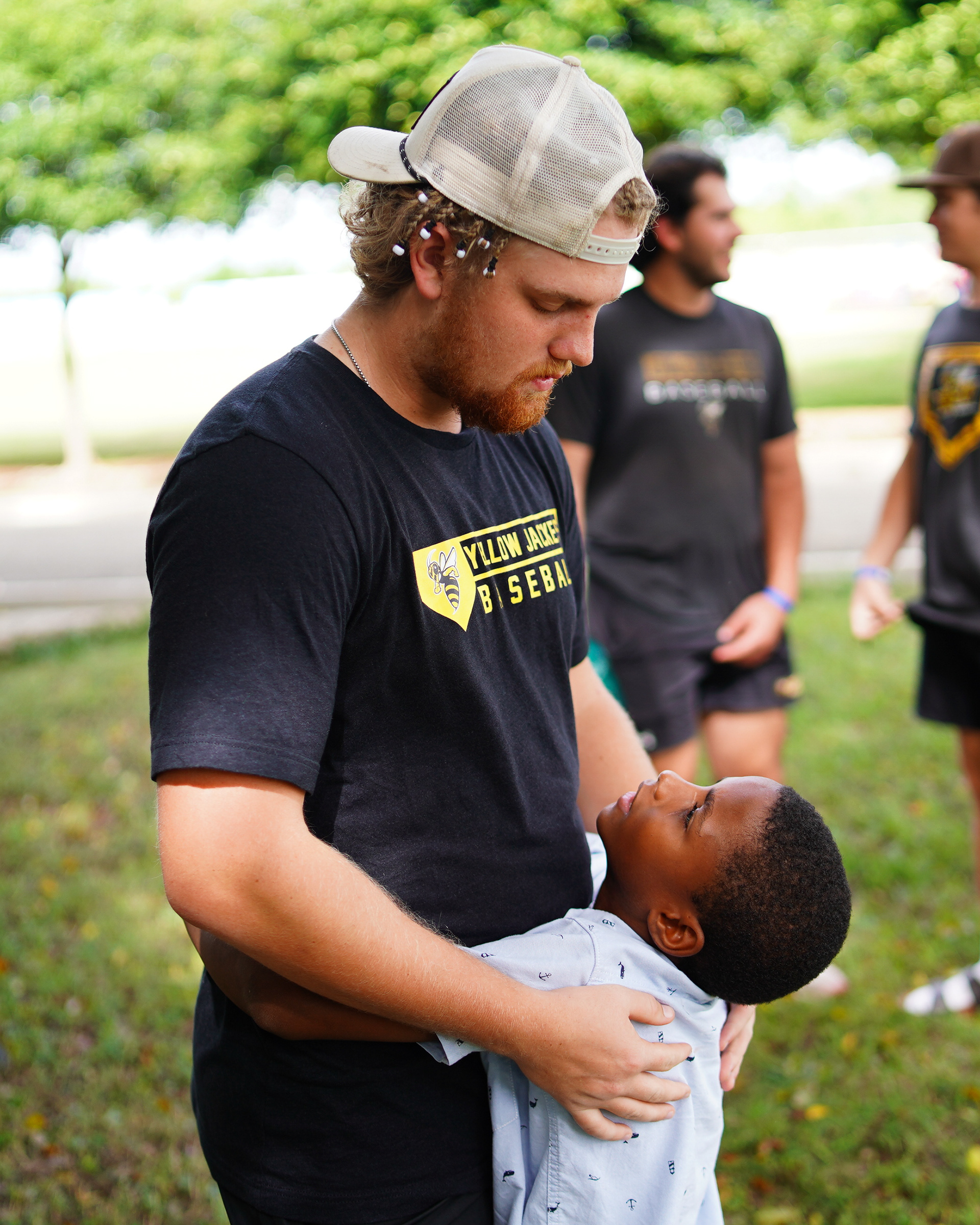 A Baldwin Wallace student shares a moment and hugs a young boy.