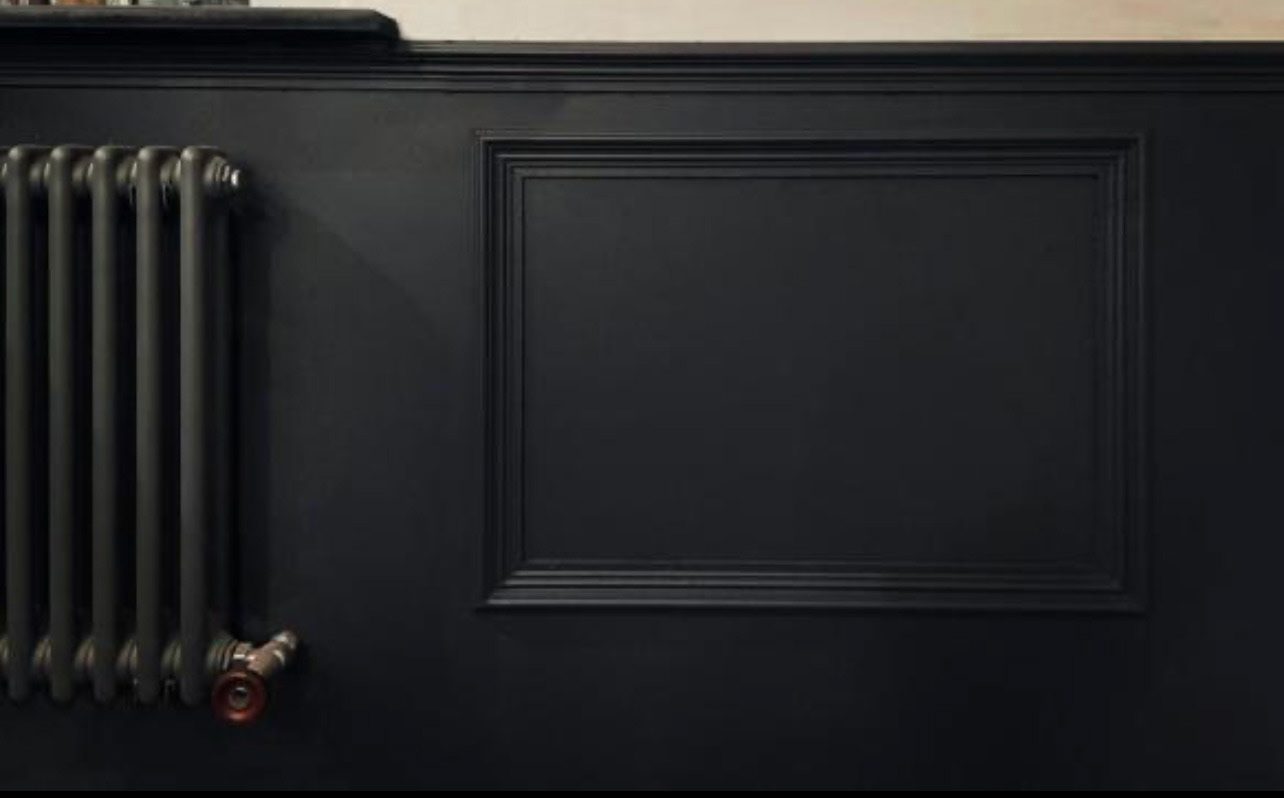Panelling in dining room with cast iron radiator