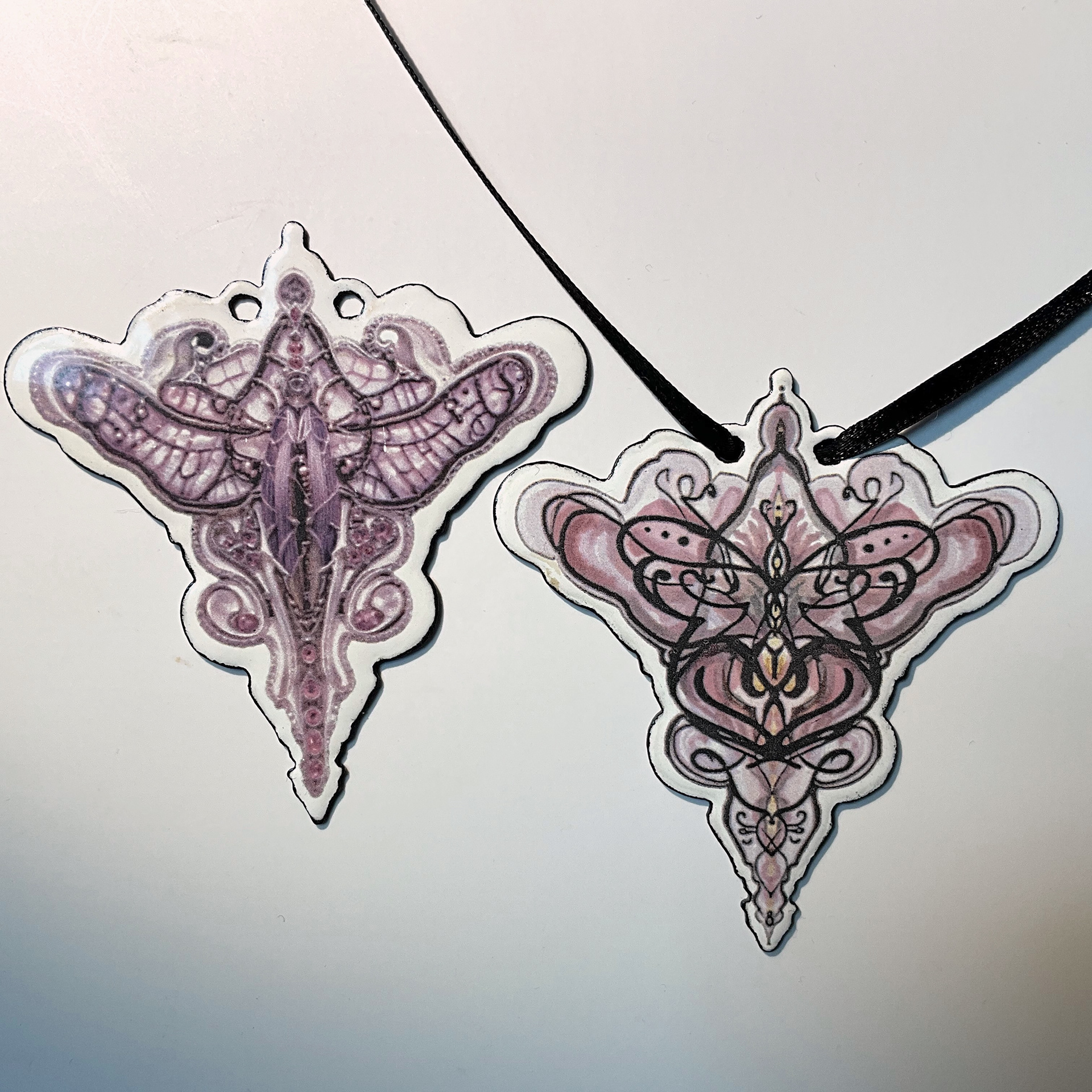 The right is the original, both burned onto enamelled steel.