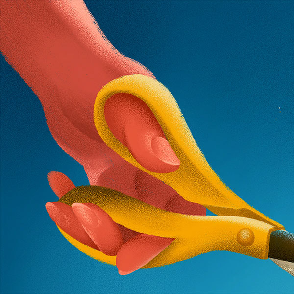 A closeup image of the hand holding the scissor.