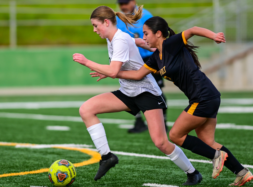 Argonaut and Ben Holt High School girls varsity soccer players battle for the ball during playoff game against Ben Holt. Photo by Duv Cardenas at the Lodi Grape Bowl