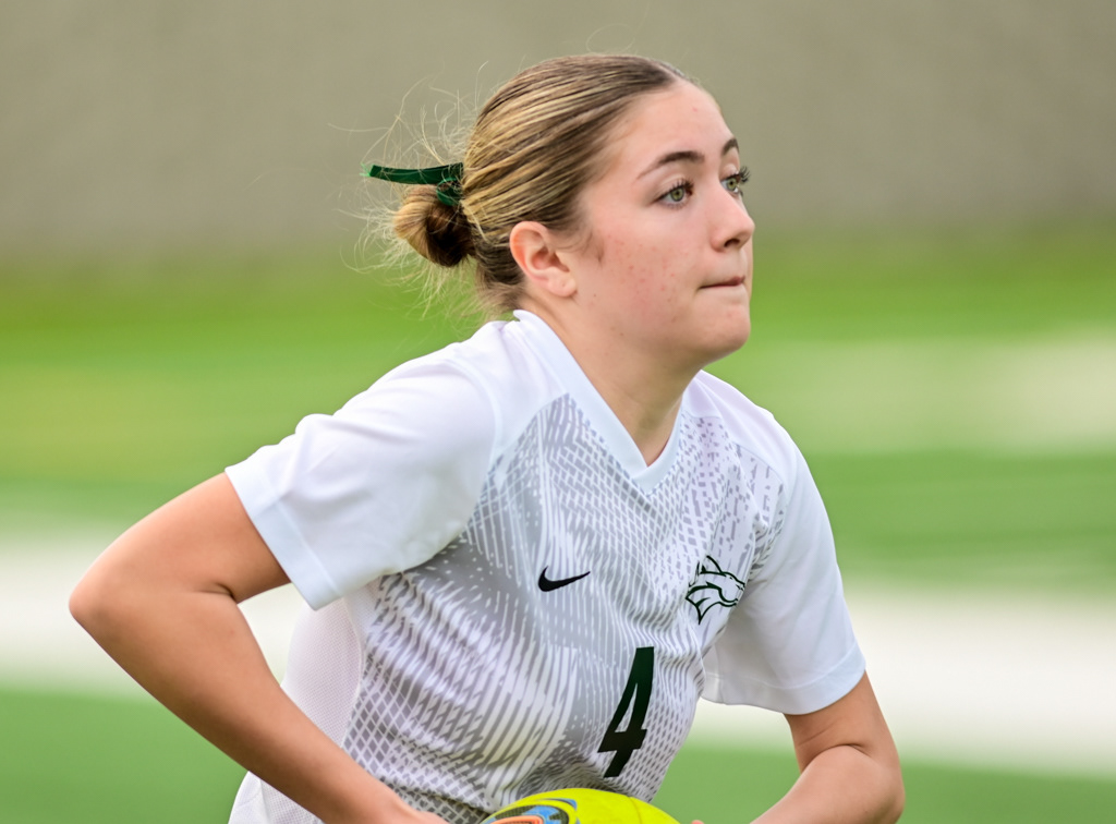 Argonaut High School girls varsity soccer player throwing the ball in during playoff game against Ben Holt. Photo by Duv Cardenas at the Lodi Grape Bowl.