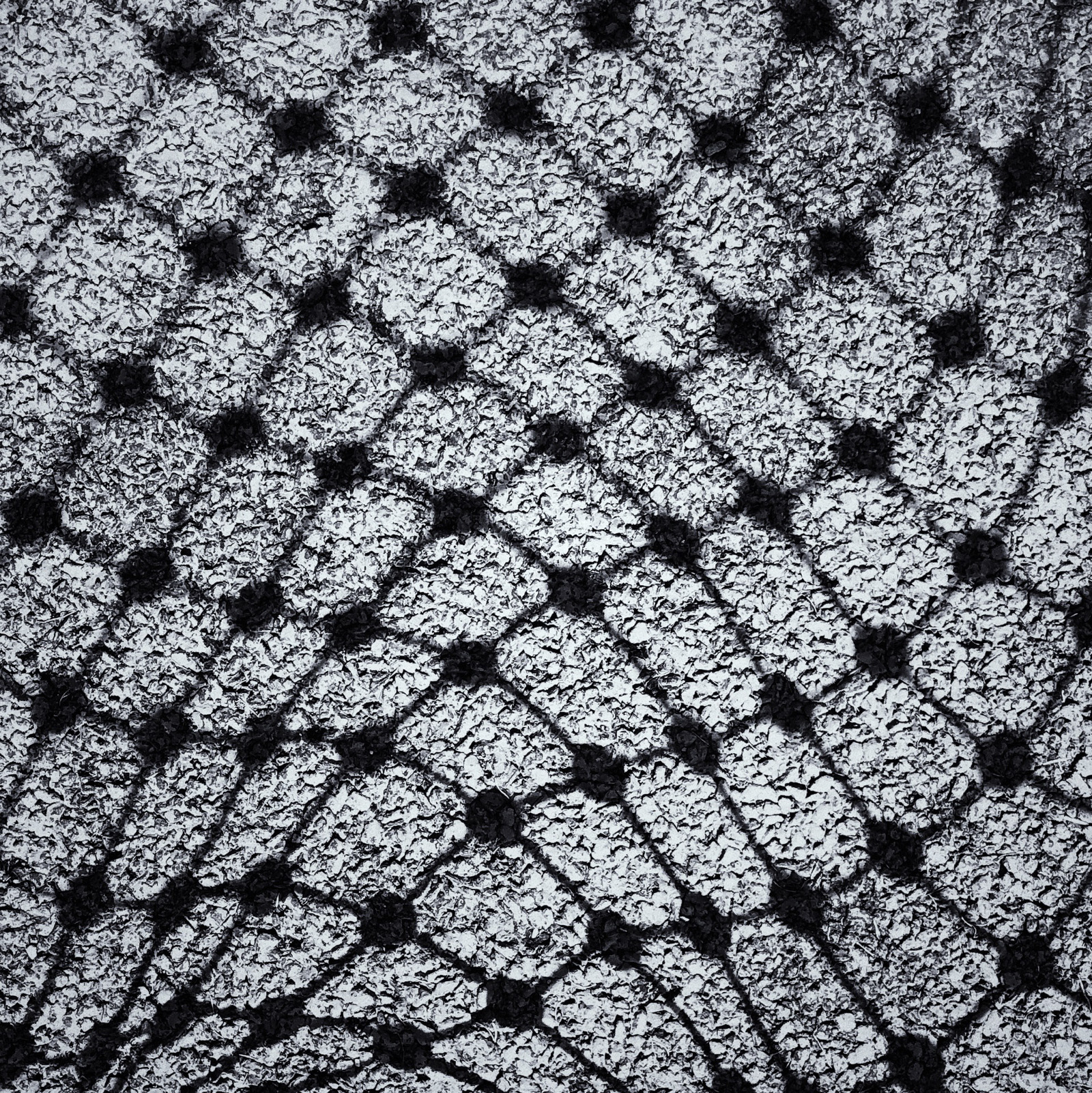 The undulation of netting on a walkway.