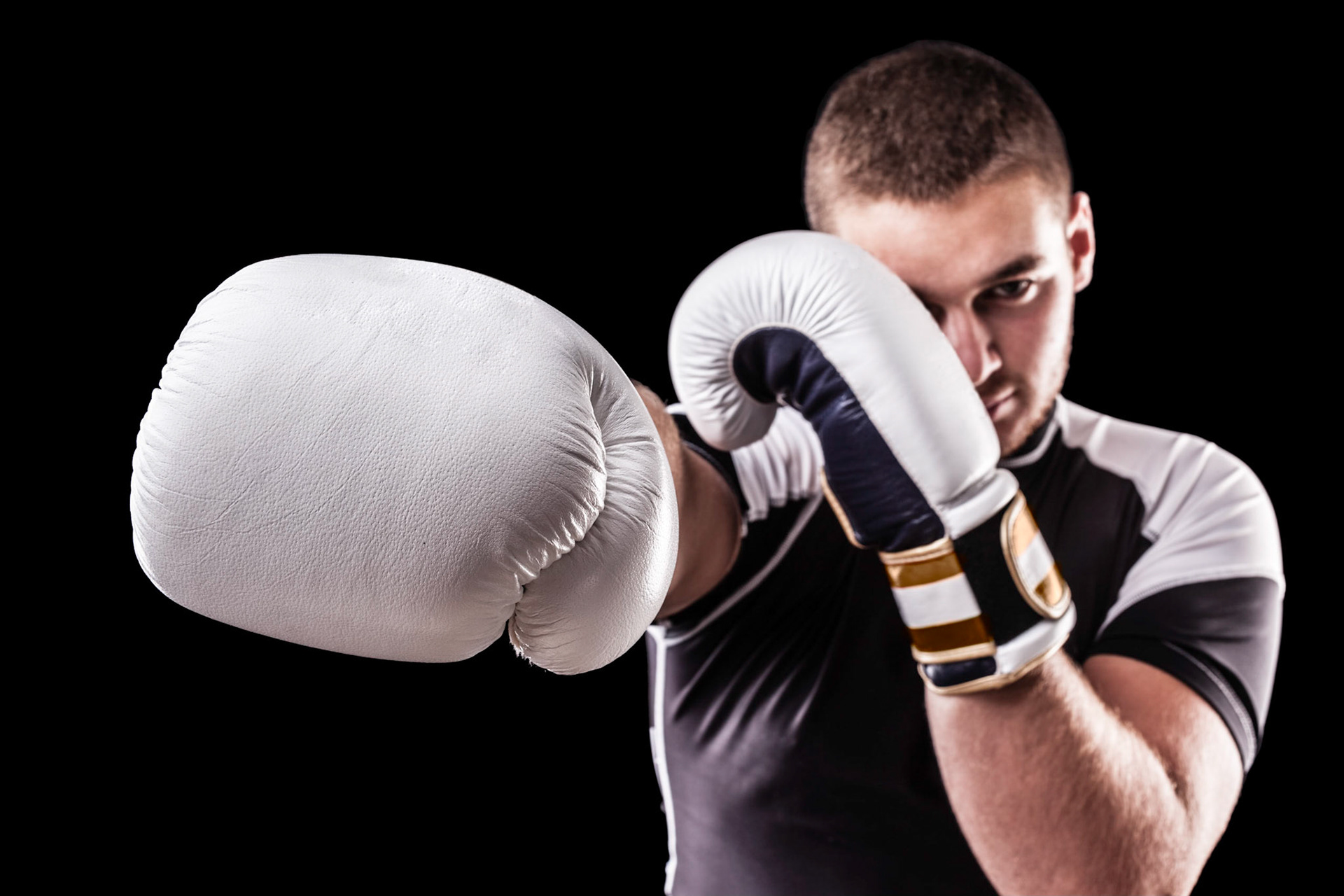 a young kickboxer or boxer isolated over a black background