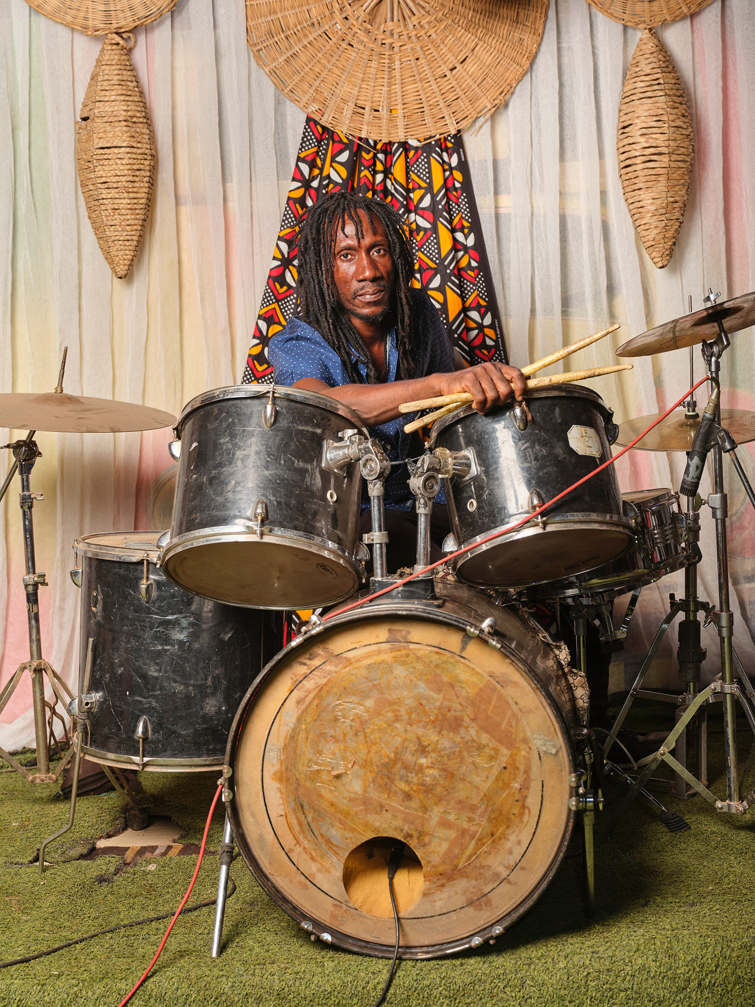 Moussa Balla Diallo plays drums with his band at Radio Libre in Bamako. During the day, he supplements his income by driving for the Heetch app. Bamako, May 2025
