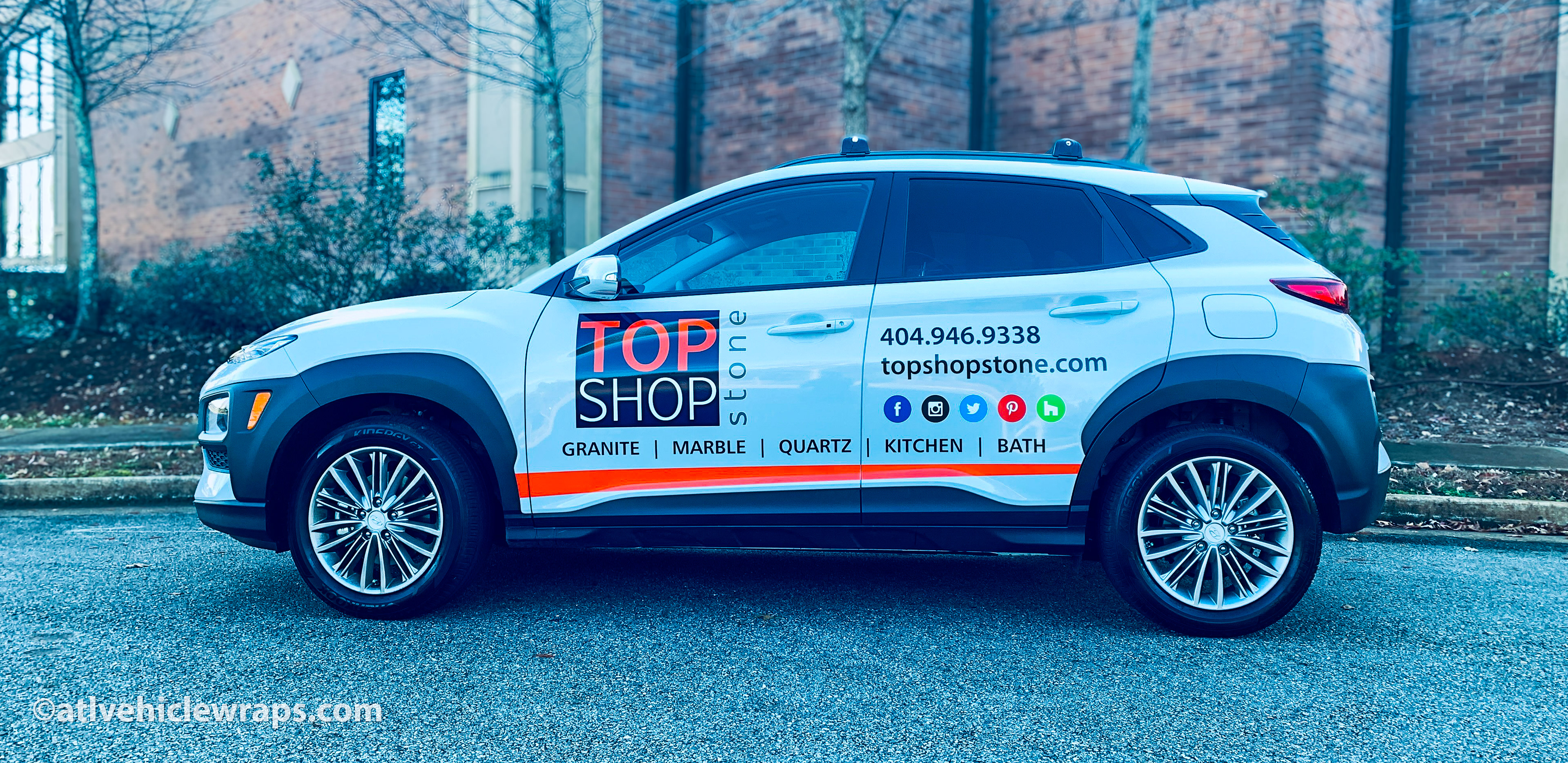 Hero image: Custom spot graphics and vinyl decals on a Hyundai Kona SUV for a stone contractor in the Atlanta region.