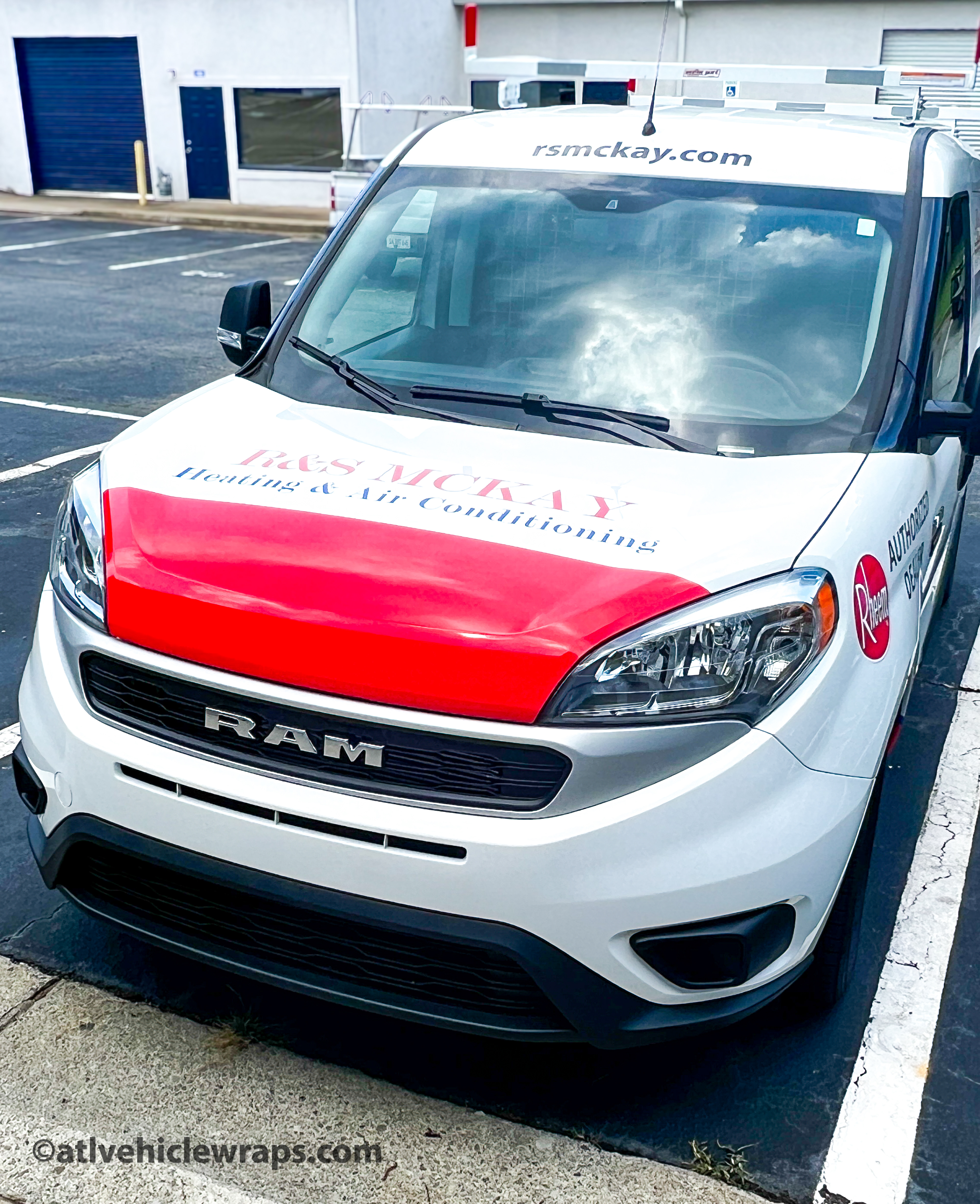 Side view of the Ram ProMaster van showcasing high-legibility HVAC spot graphics in Lawrenceville.