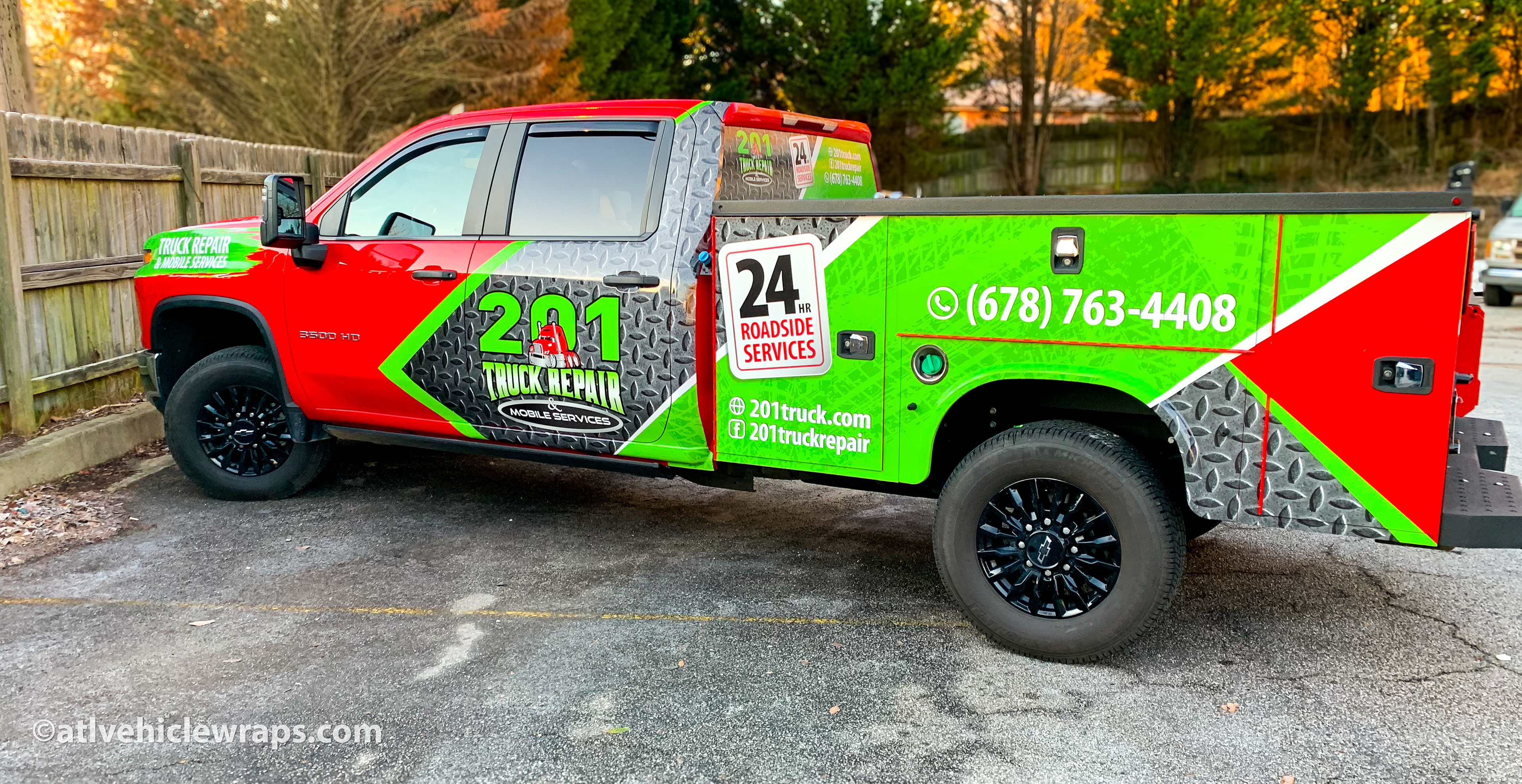 Side profile of the professionally installed partial wrap on the Chevy 3500 HD service truck.