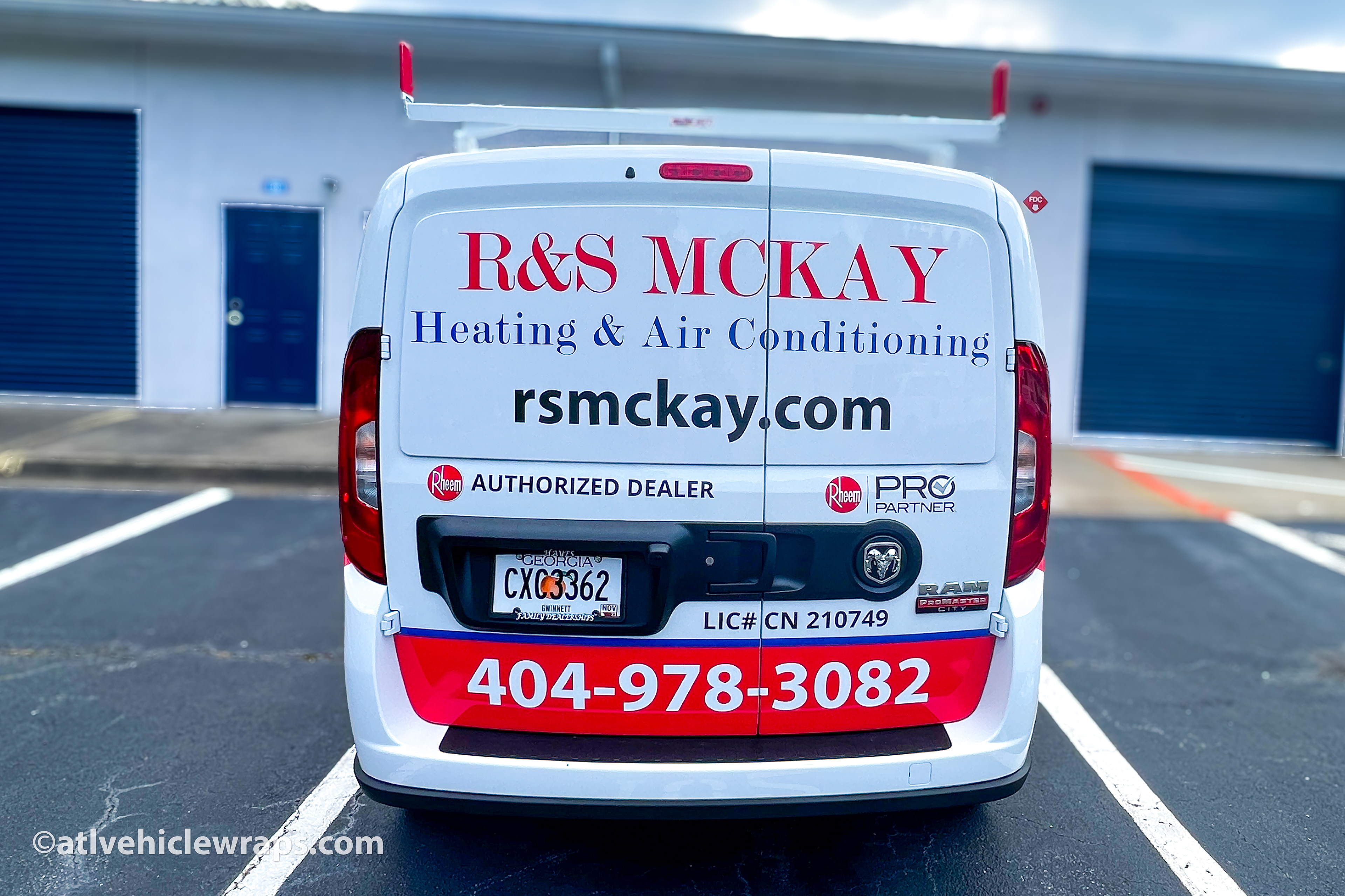 Close-up of the heating and cooling company's logo and crisp vinyl decals on the Ram ProMaster van.