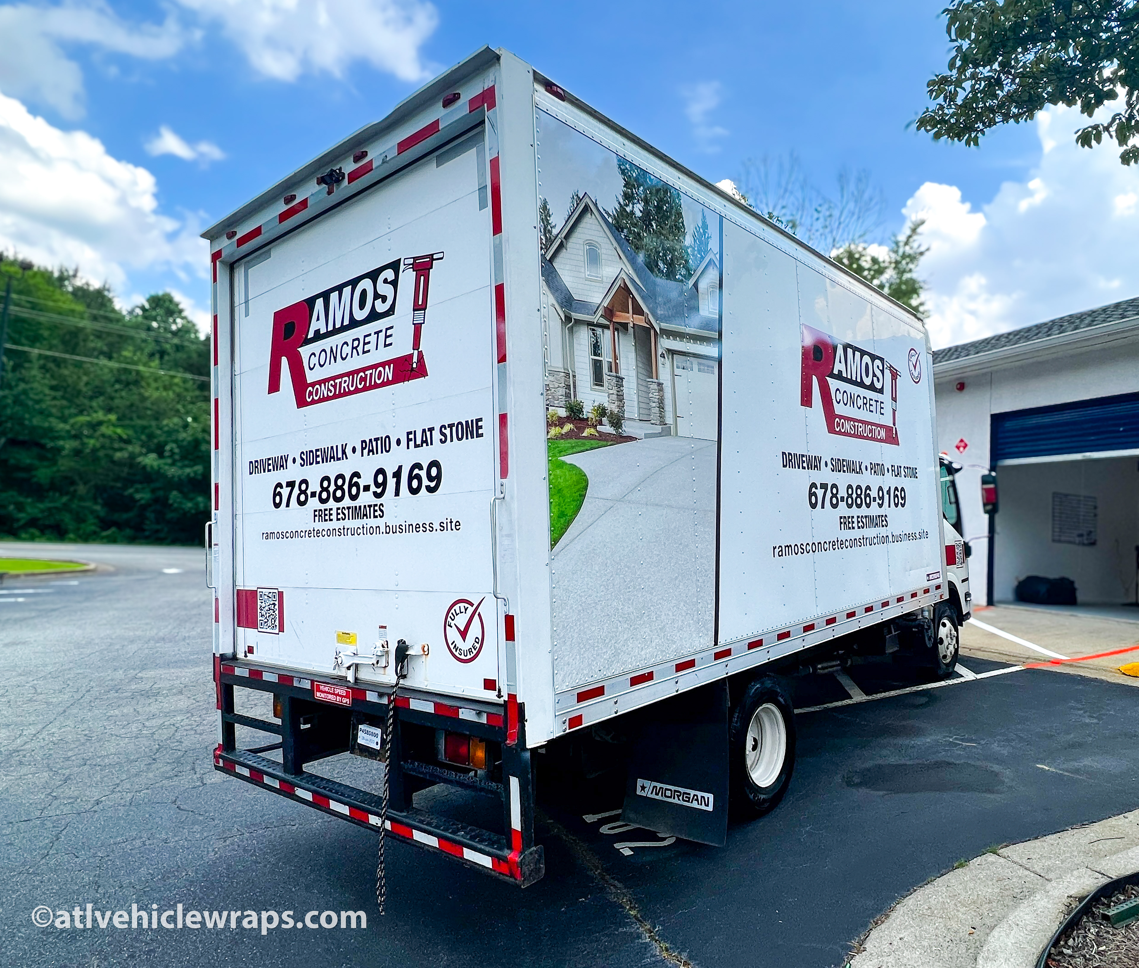 Close-up of the concrete company's logo and contact details on the partial wrap of the Isuzu box truck.