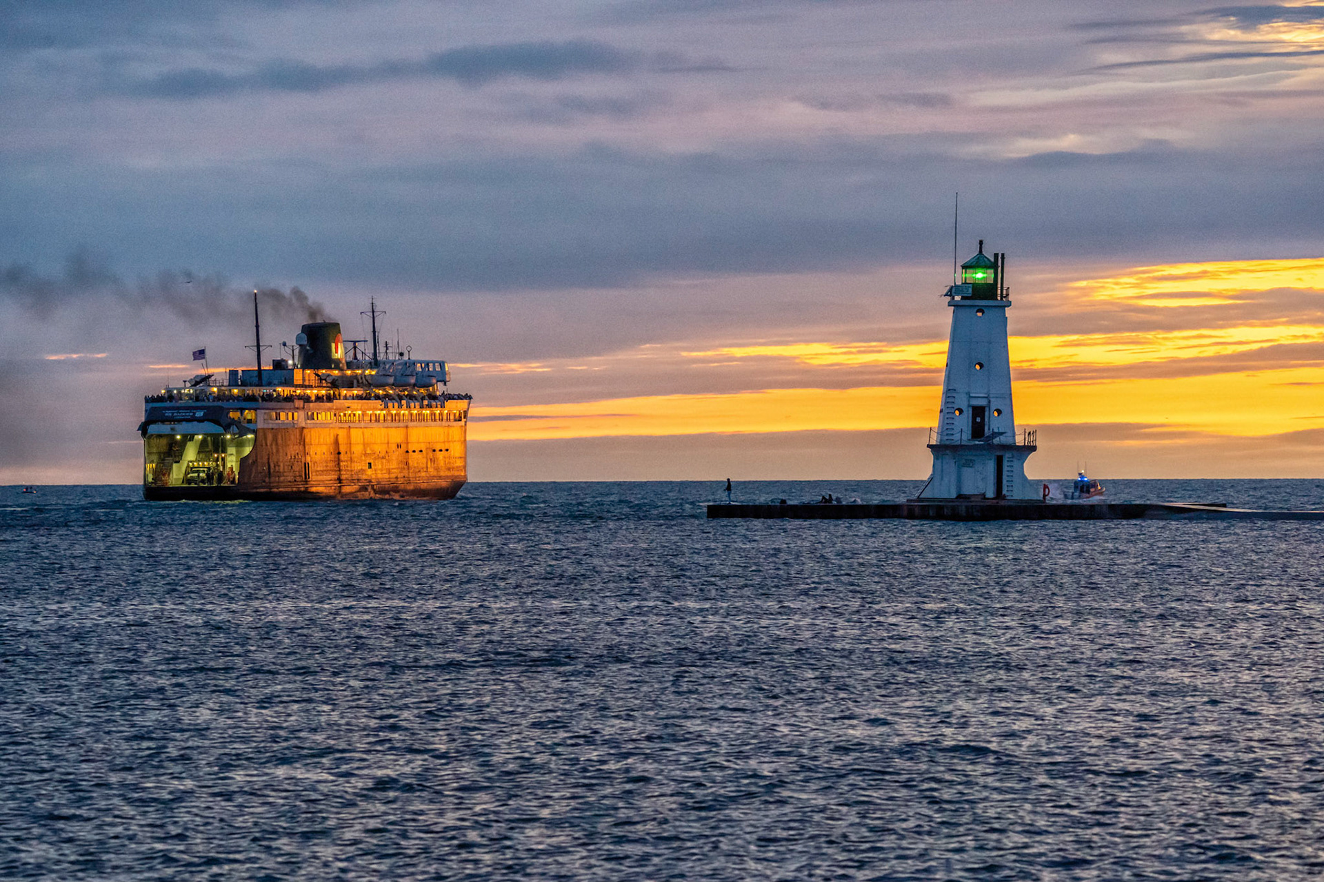 The ferry S.S. Badger
leaving Ludington Harbor at sunset past the Ludington Light.
