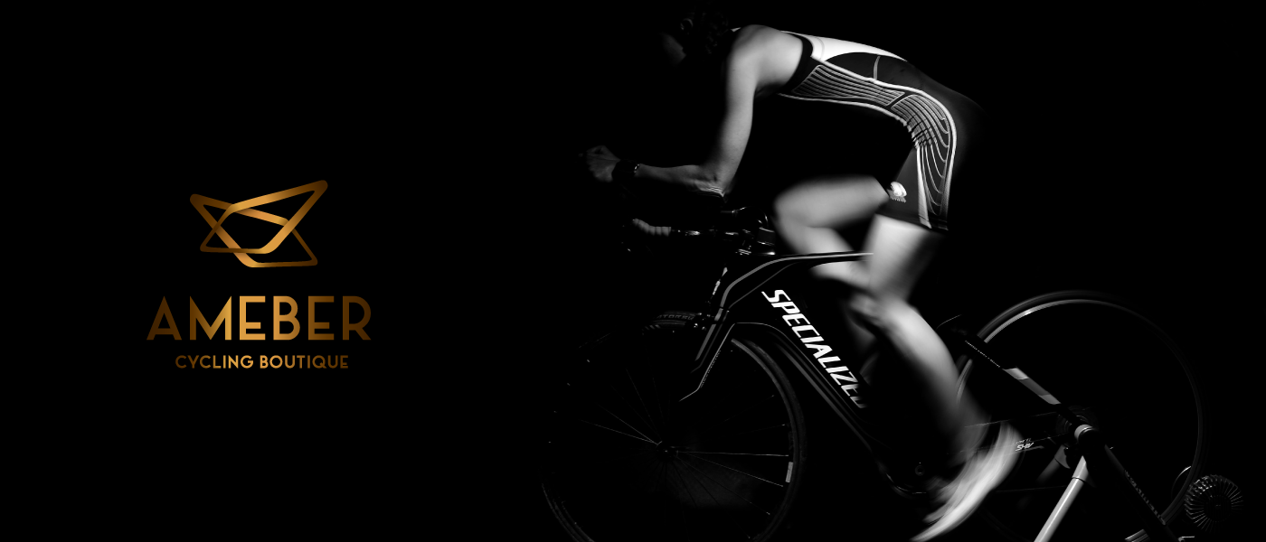 dramatic shot of a cyclist with orange logo of ameber cycling boutique