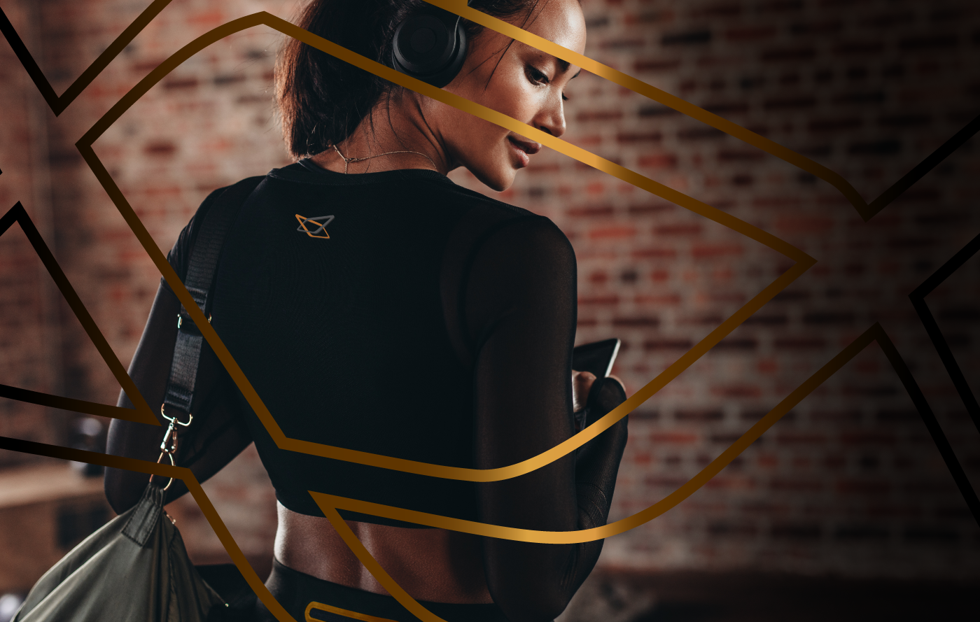 asian filipino woman in gym black clothes with black headphones and gym bag, with black and orange layout stripes