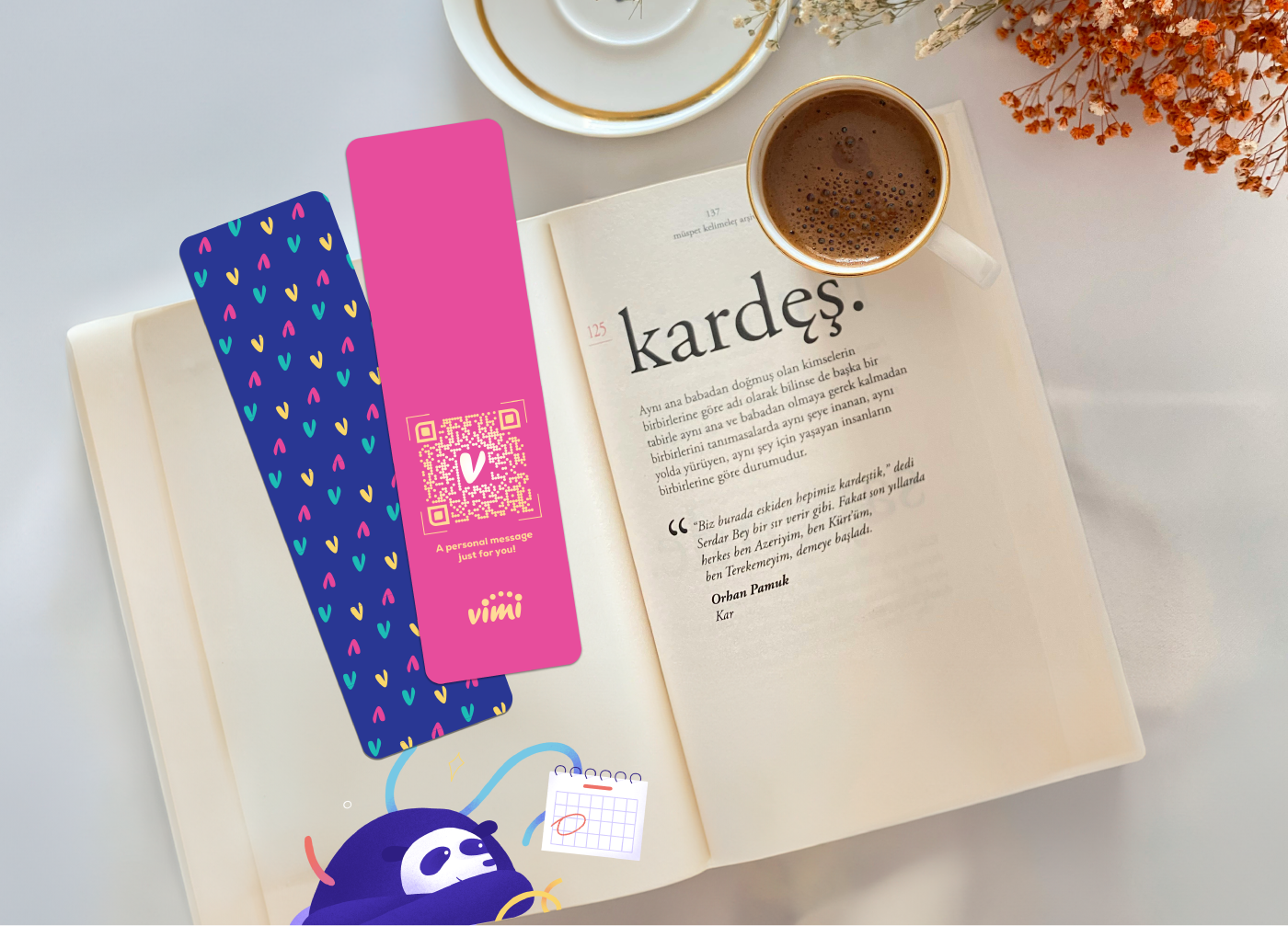 book flatlay shot with espresso cup and 2 colorful vibrant bookmarks with heart patterns and vimi qr code