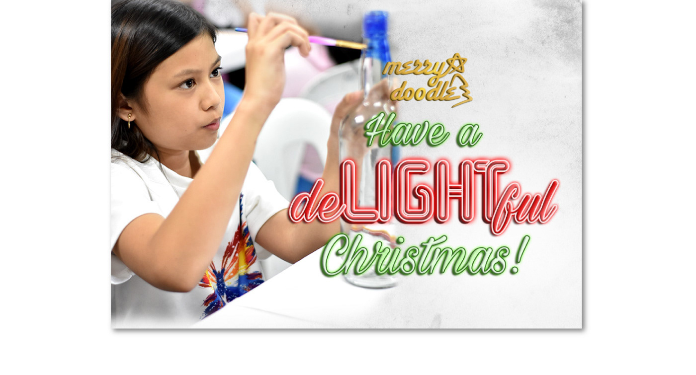 Kid painting bottle for Christmas light exhibit with Merry Doodle logo, Have a deLIGHTful Christmas