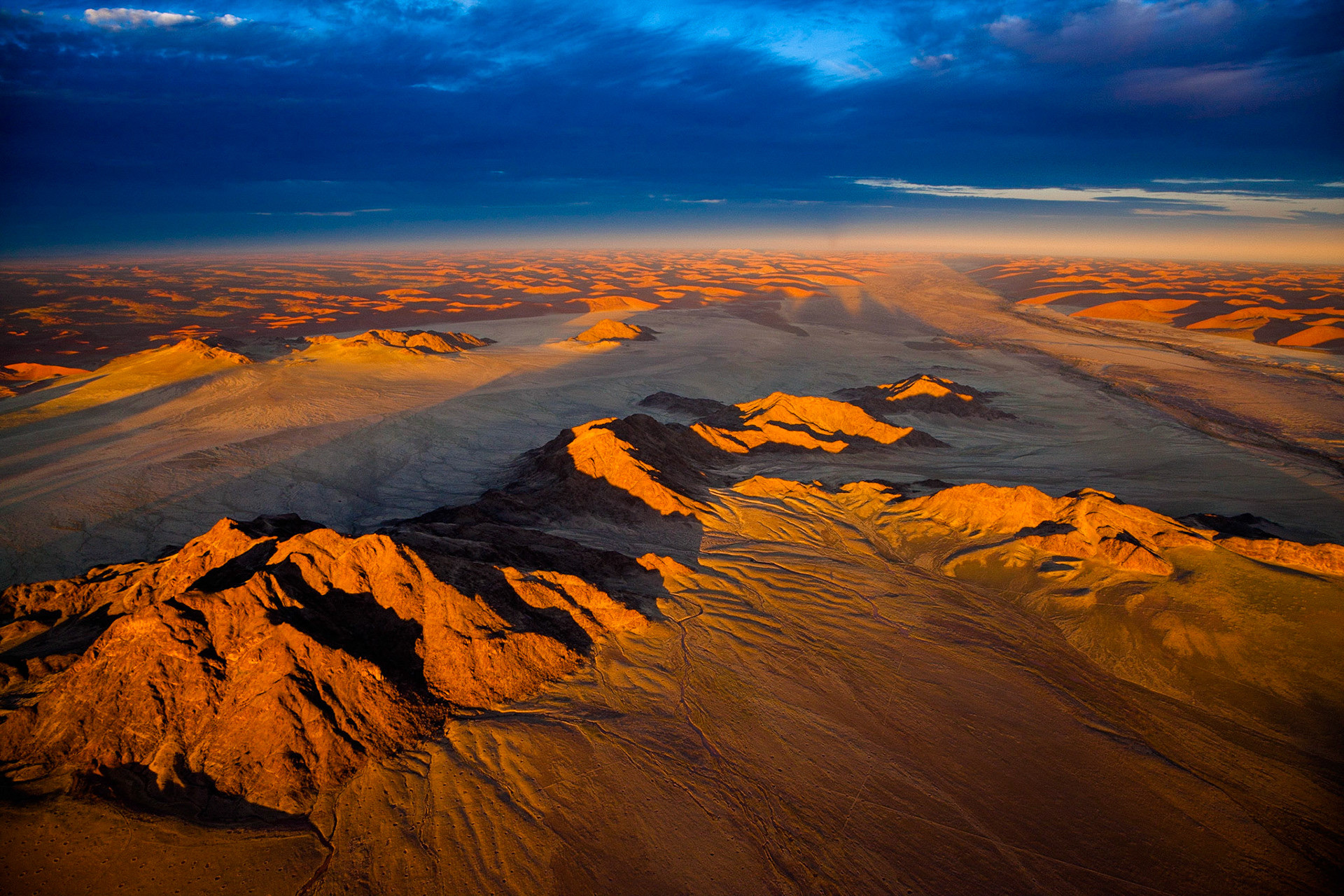 Na poušti je podívaná zvláště úchvatná při východu a západu slunce, kdy barvu a tvary okolních dun ještě více umocňuje dopadající oranžové světlo spolu s fantaskní stínohrou. Vstávám v 5 hodin ráno. O 2 hodiny později se již neslyšně odlepujeme v horkovzdušném balonu od země, abychom stihli první paprsky slunce vycházejícího nad Namibem. Slunce barví poušť doruda a v dáli za mořem písku probleskuje slabý modrý proužek Atlantiku.