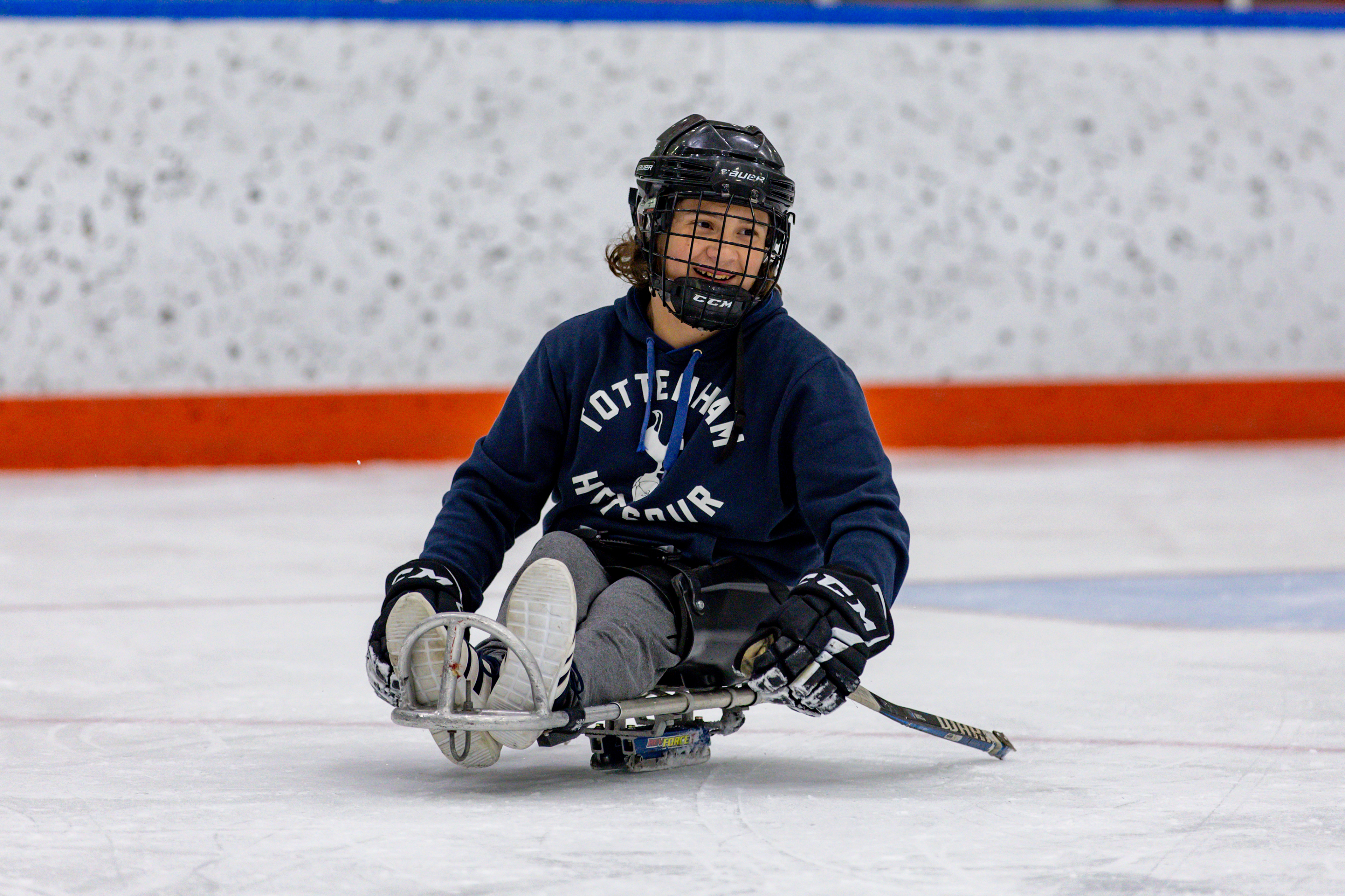 Myles smiles on the ice during a team practice at Tennity Ice Pavilion.   For Myles, like most teenage boys, sports are a central part of life. Whether managing his high school’s hockey team or competing with the Flyers, sports allow Myles to express himself, compete, and connect with others experiencing the same struggles.   “I may be playing a different sport, but I’m still playing sports,” Myles says, “I found a sport that I love to play and I can play. There’s nothing better than that.”
