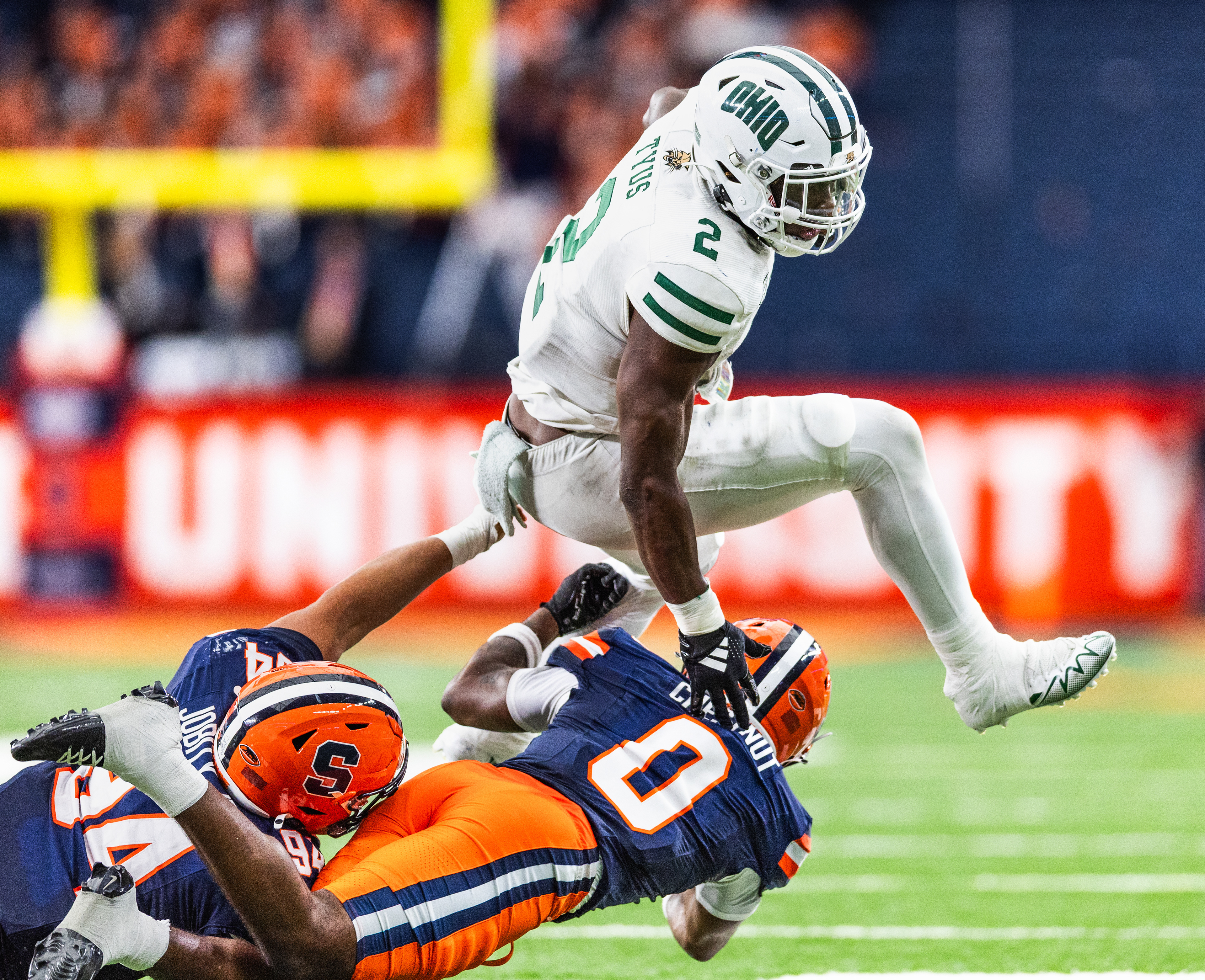 Ohio running back Anthony Tyus III (2) leaps over Syracuse defenders Duce Chestnut (0) and Kevin Jobity Jr. (94) during the college football season opener at JMA Wireless Dome on Aug. 31, 2024, in Syracuse, N.Y.