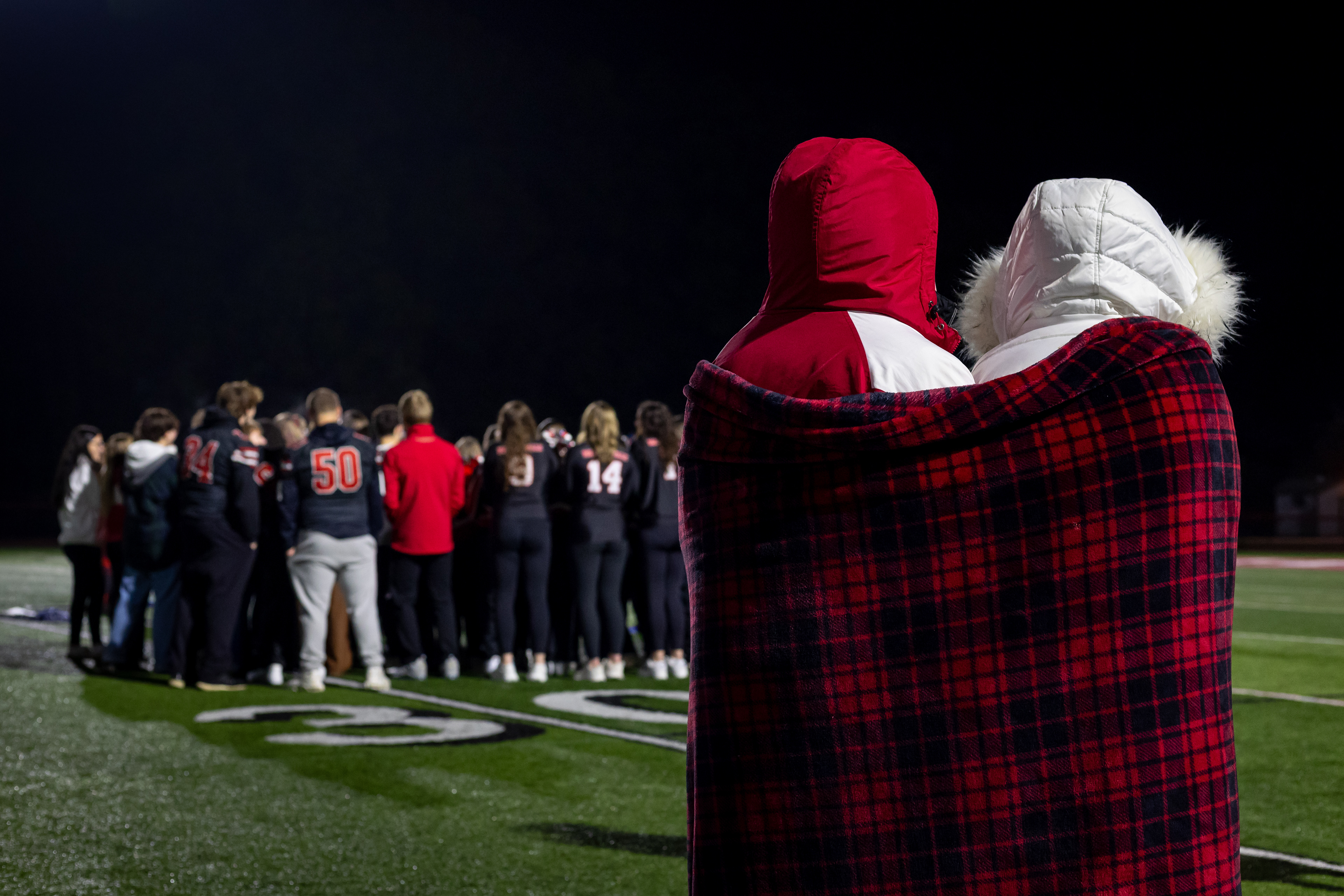 Abbey, left, and Peyton Edwards, her teammate, and best friend, watch the squad from afar during their feature on Channel 9, as they were unable to participate. Abbey doesn’t view this setback as the end of her cheerleading career and is waiting for medical clearance to return to the sport she’s loved since she was six.