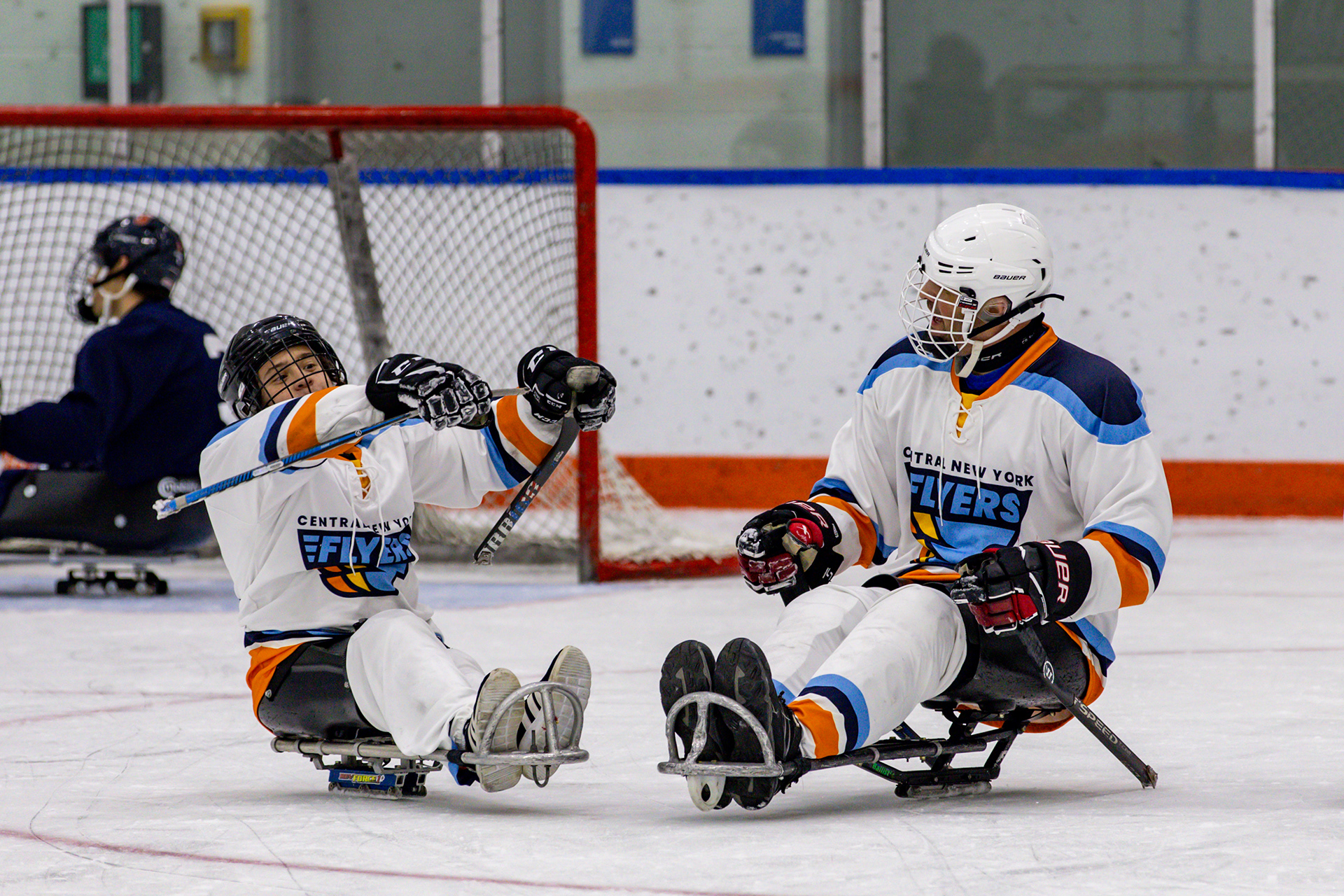 Myles celebrates with his father after scoring a goal against the Syracuse men’s club hockey team.   Weekly practices didn’t just spark Myles’ love for the sport; they also sparked Jamie’s. Over time, Jamie found himself becoming an integral part of the team. During the 2019-2020 season, he took on the role of team manager, dedicating his efforts to ensuring the team's continued existence for Myles.