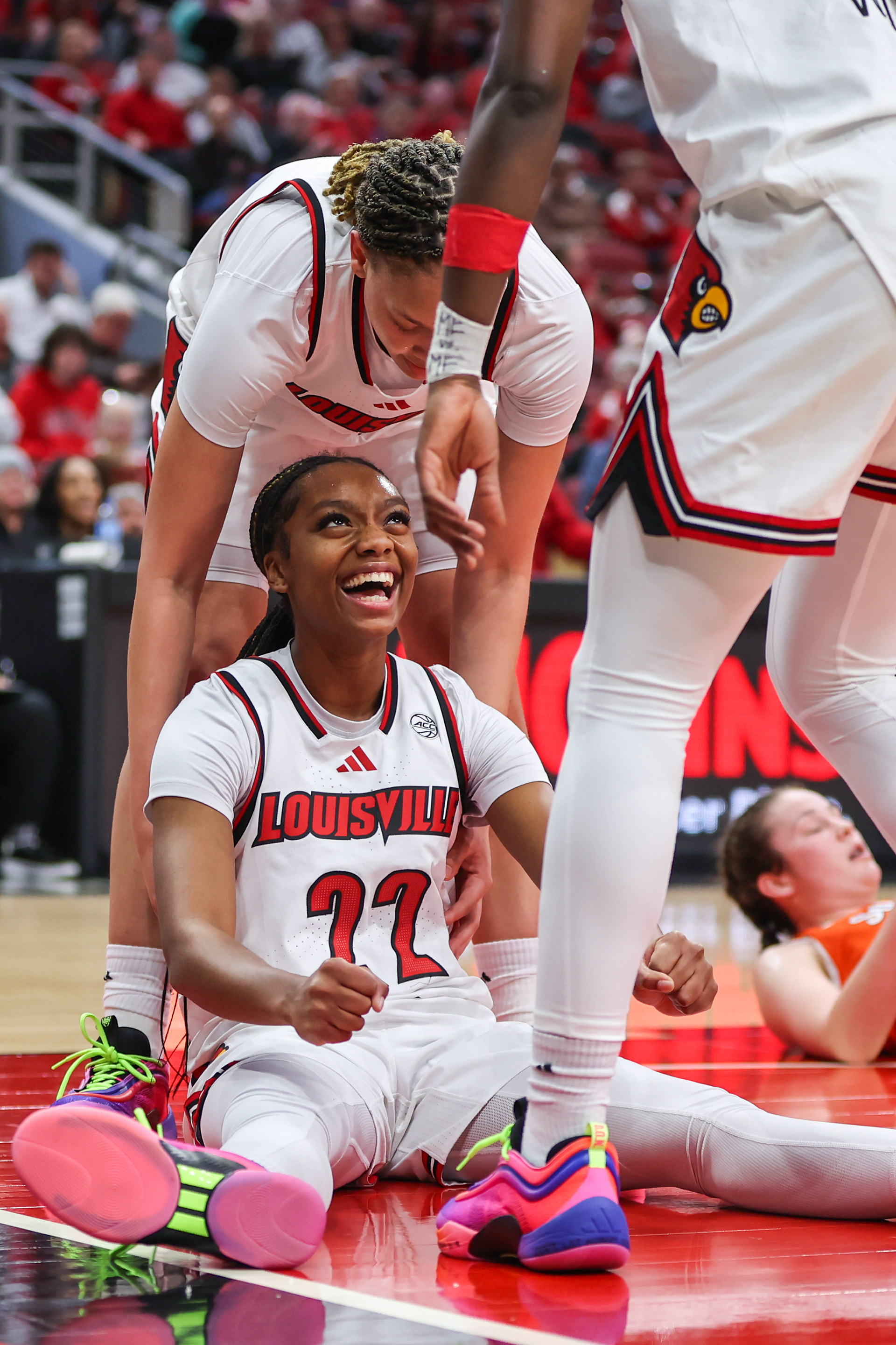 Louisville guard Tajianna Roberts (22) celebrates with teammates after an offensive foul was called on Syracuse guard Sophie Burrows during the second quarter of a college basketball game on Jan. 16, 2025, in Louisville, Ky.