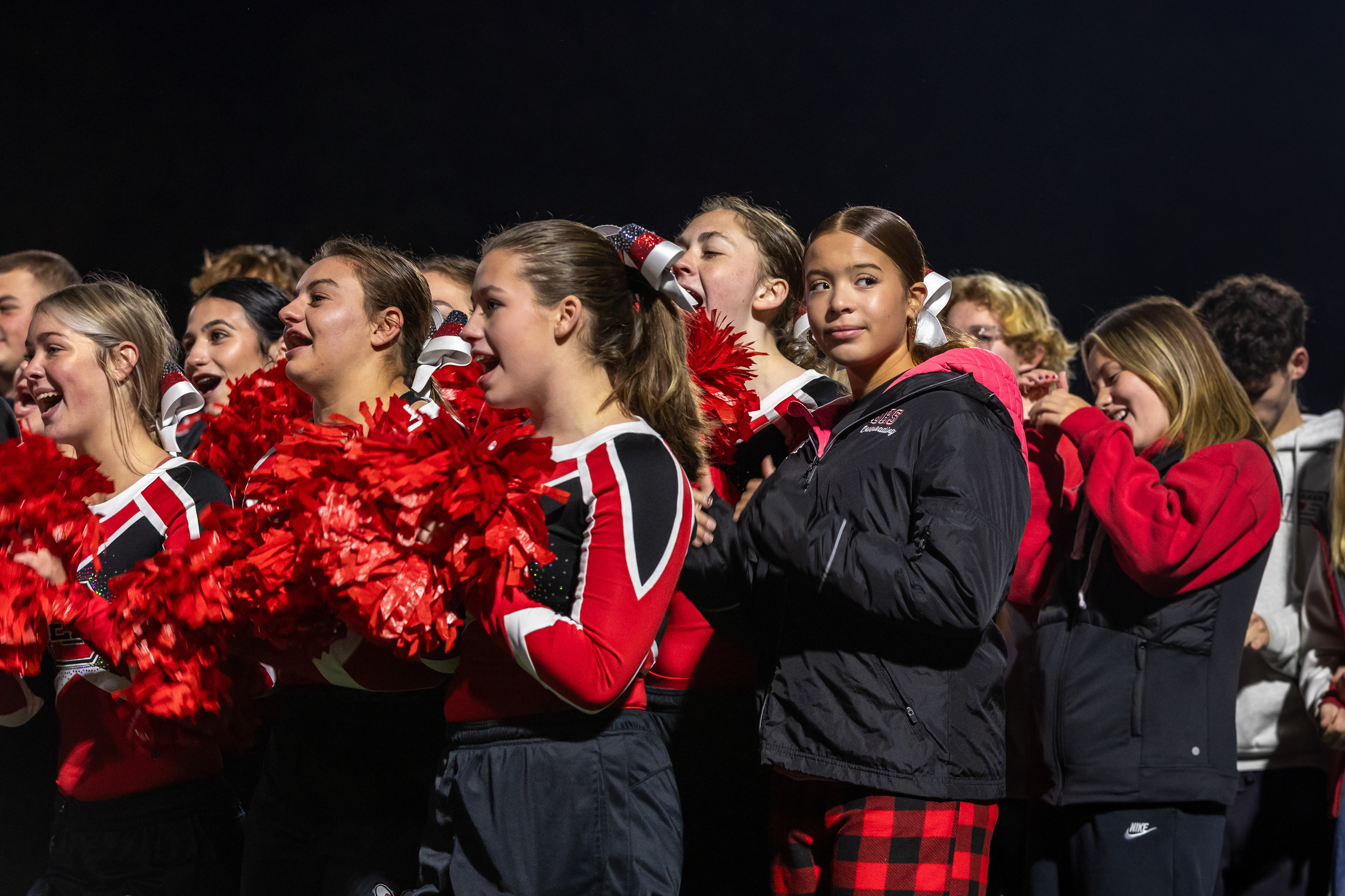 Abbey Fawcett, a member of the Baldwinsville Bees’ cheer team, stands with her team during a feature on Channel 9’s Friday Morning Lights. The 16-year-old is currently unable to cheer after surviving cardiac arrest, a condition only 10% of people survive outside of a hospital, at cheer camp over the summer.