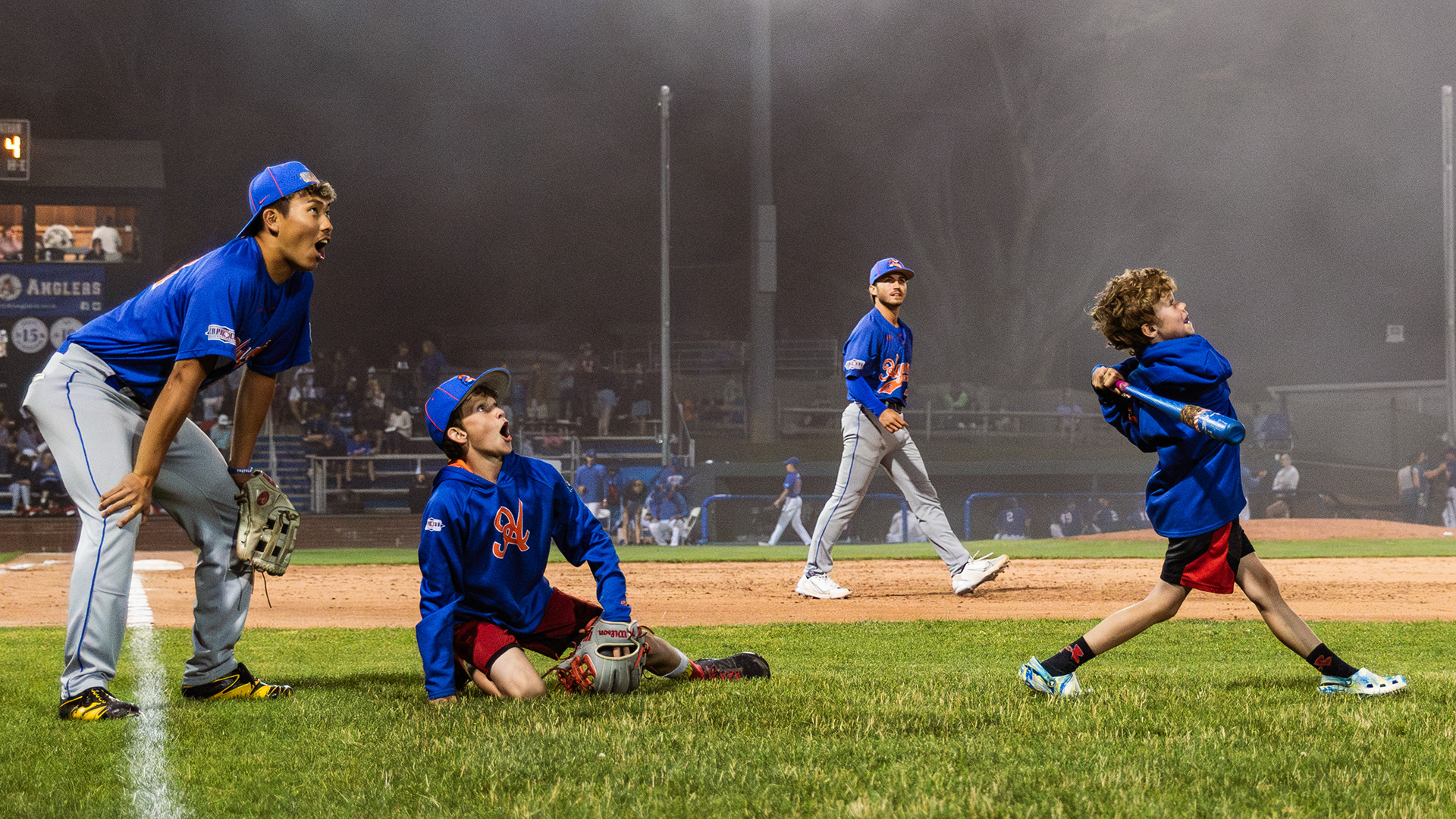 Hyannis Harbor Hawks pitcher Hiroyuki Yamada passes time playing wiffle ball alongside the coaching staff’s children during a fog delay in Chatham, Mass., on July 1, 2023.